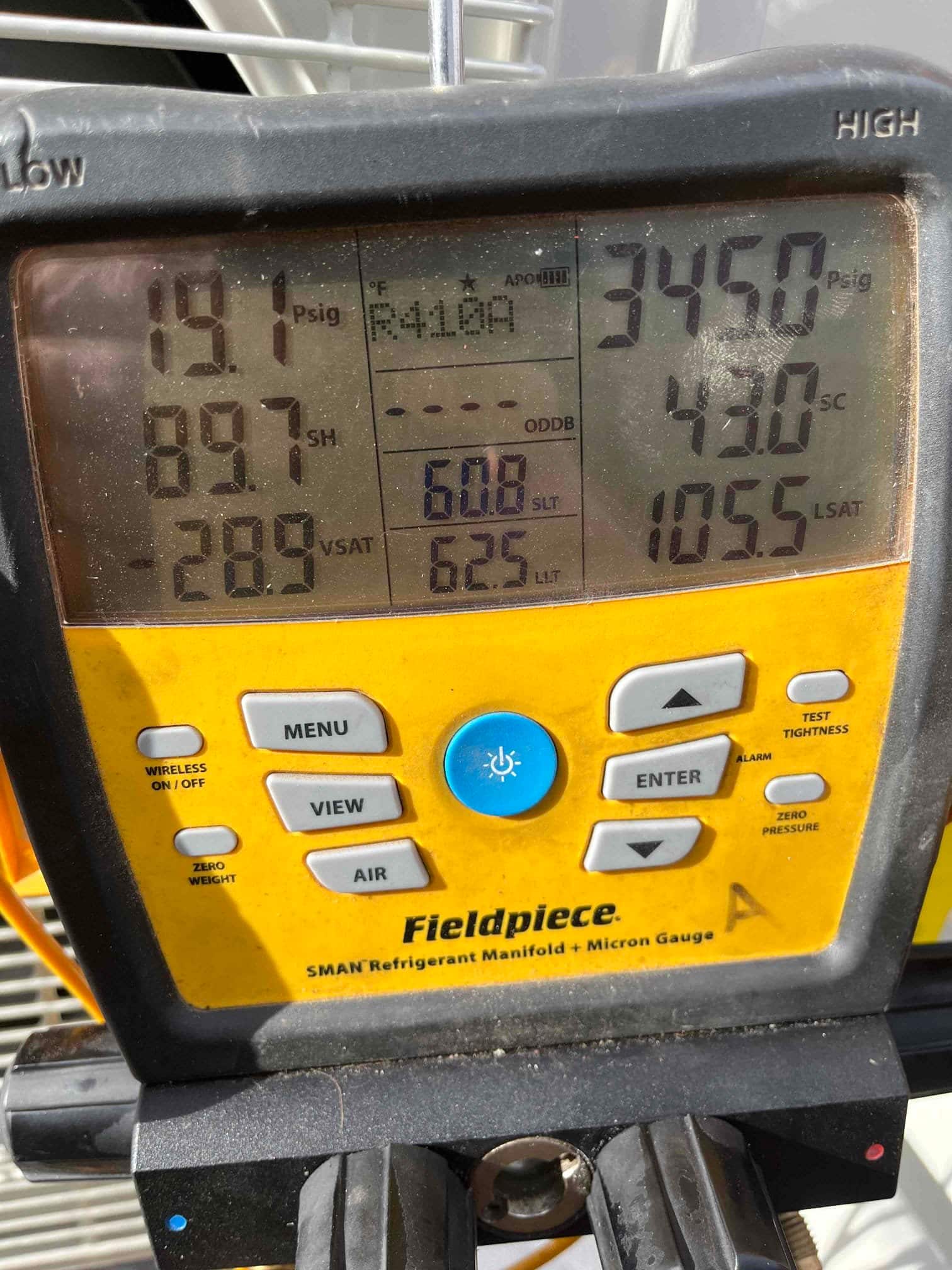 Digital manifold shows system operating with suction 191 PSI and liquid 345 PSI on R-410A during commissioning.