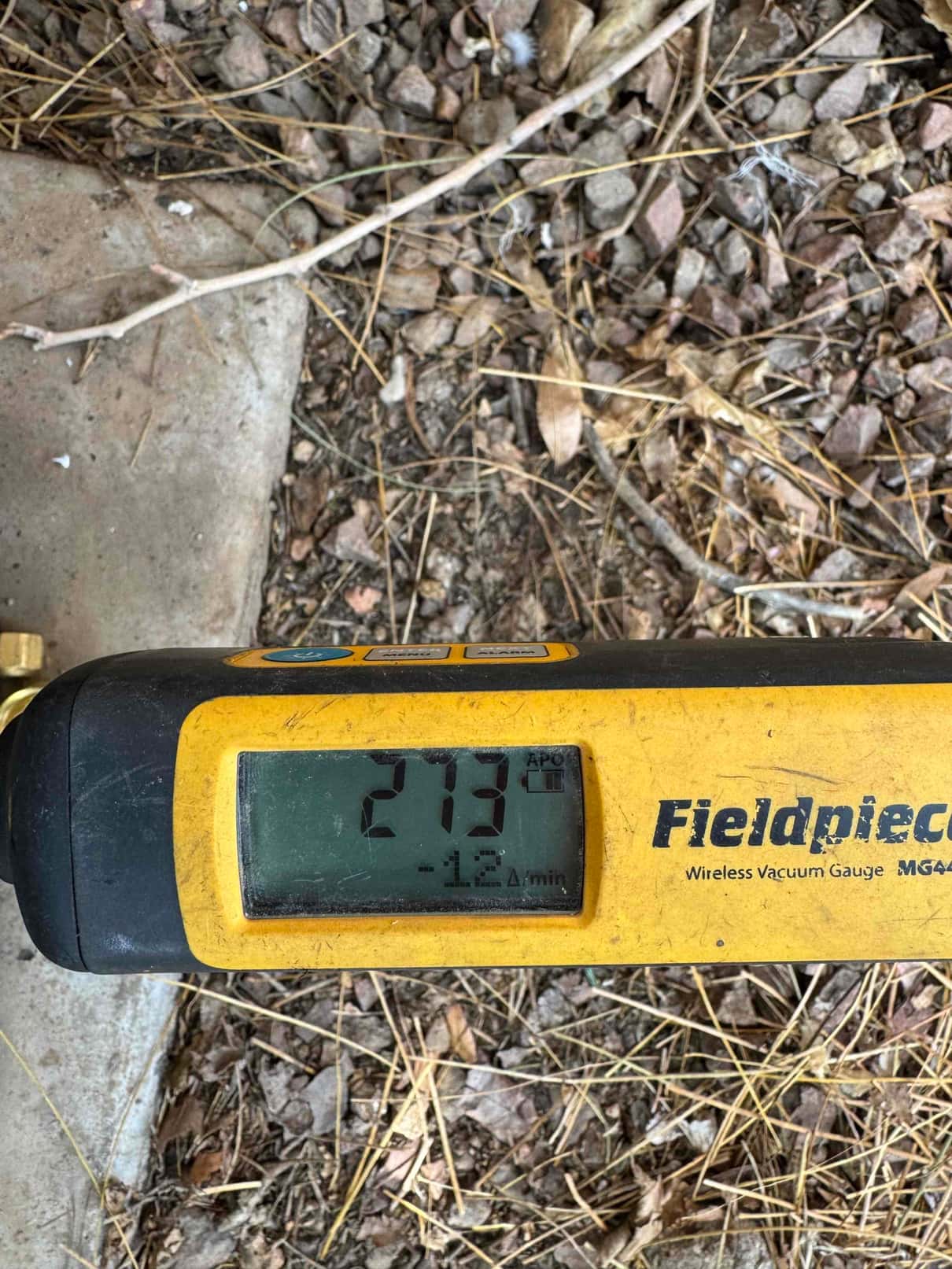 Digital micron gauge displays 273 microns during evacuation, confirming a deep vacuum on the newly installed HVAC system.