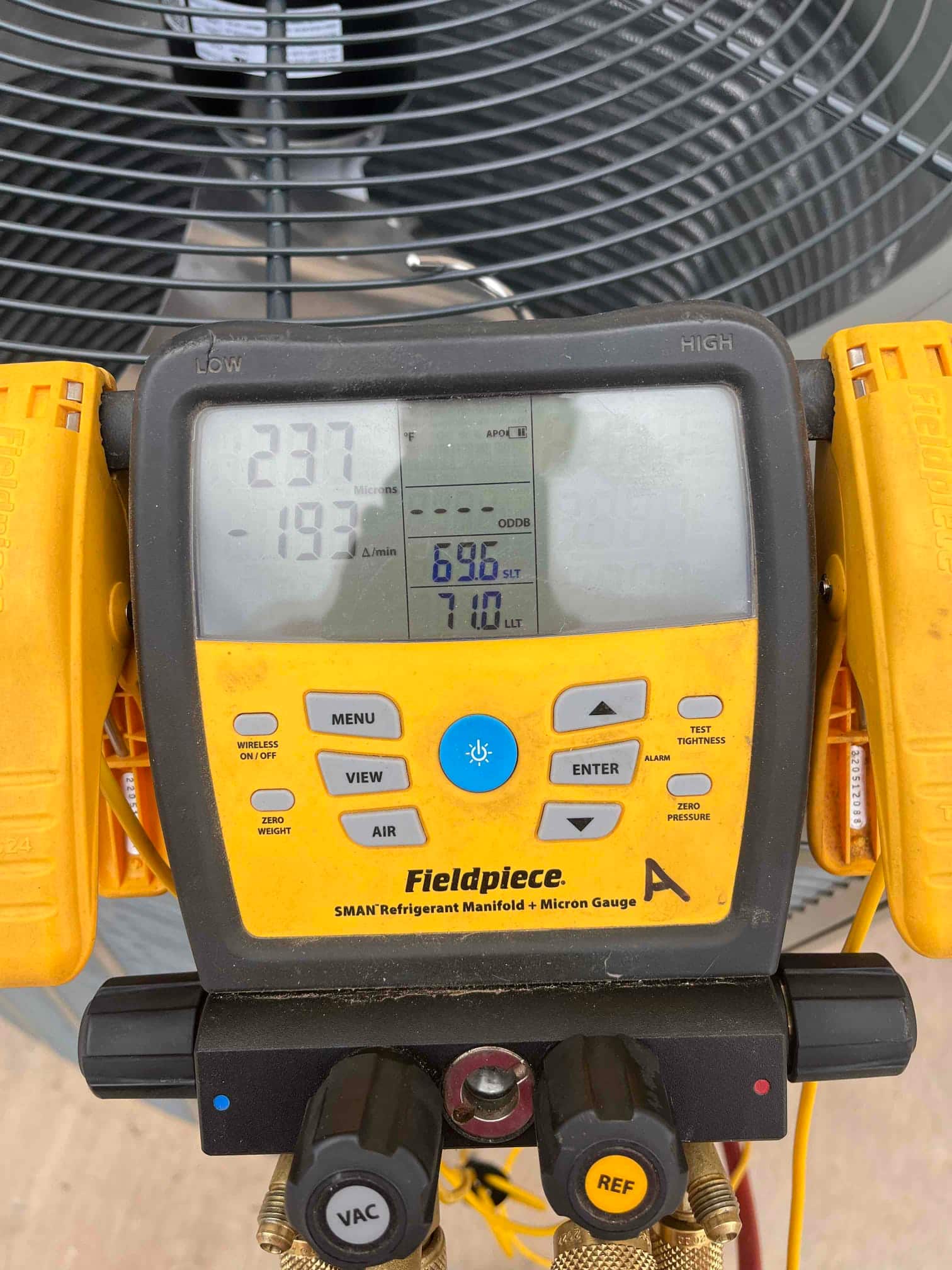 Digital micron gauge on the manifold shows 237 microns with a decreasing rate, documenting deep vacuum during system evacuation.