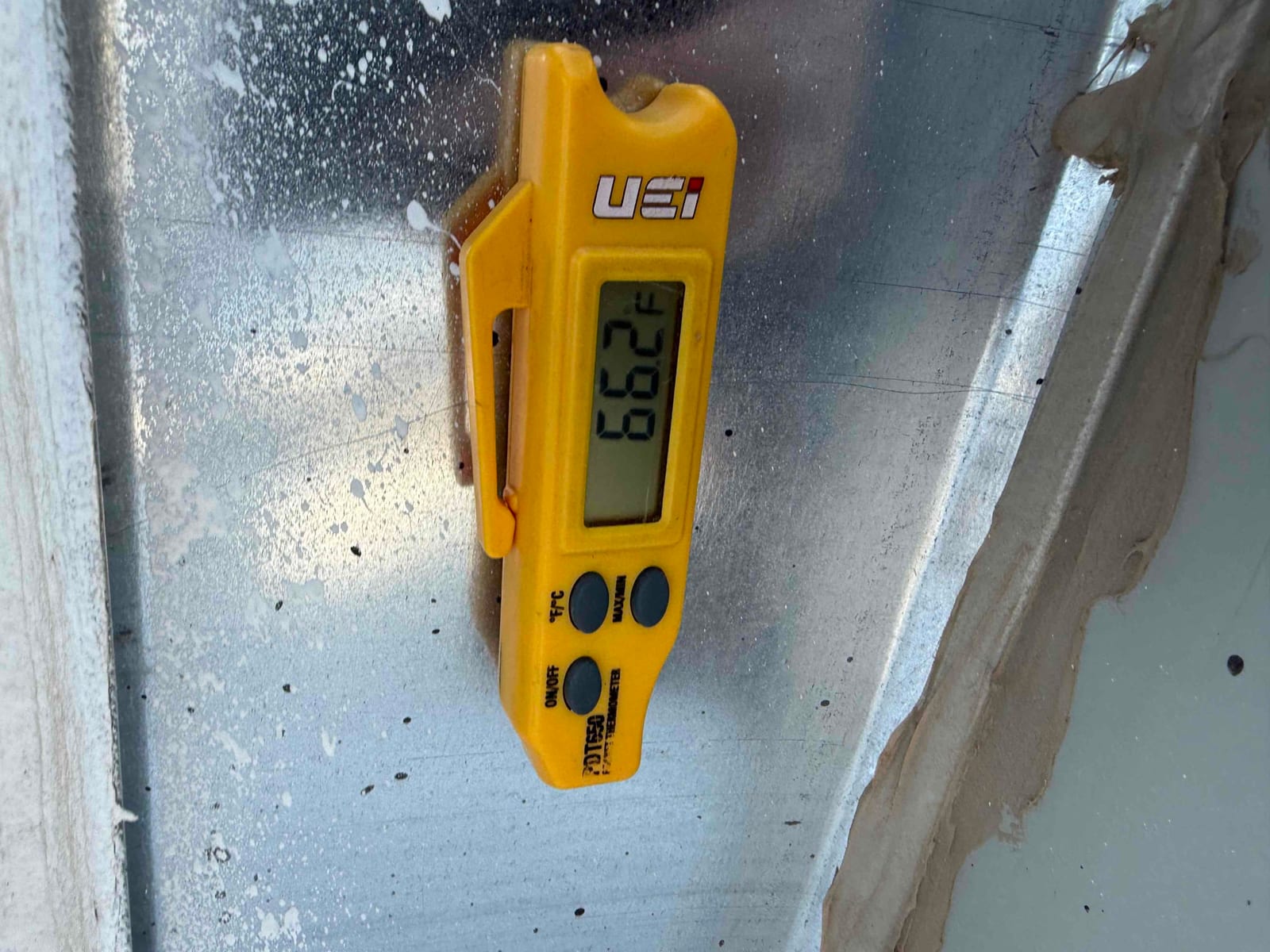 Digital thermometer clipped to metal duct shows a surface temperature of 72.9 °F.