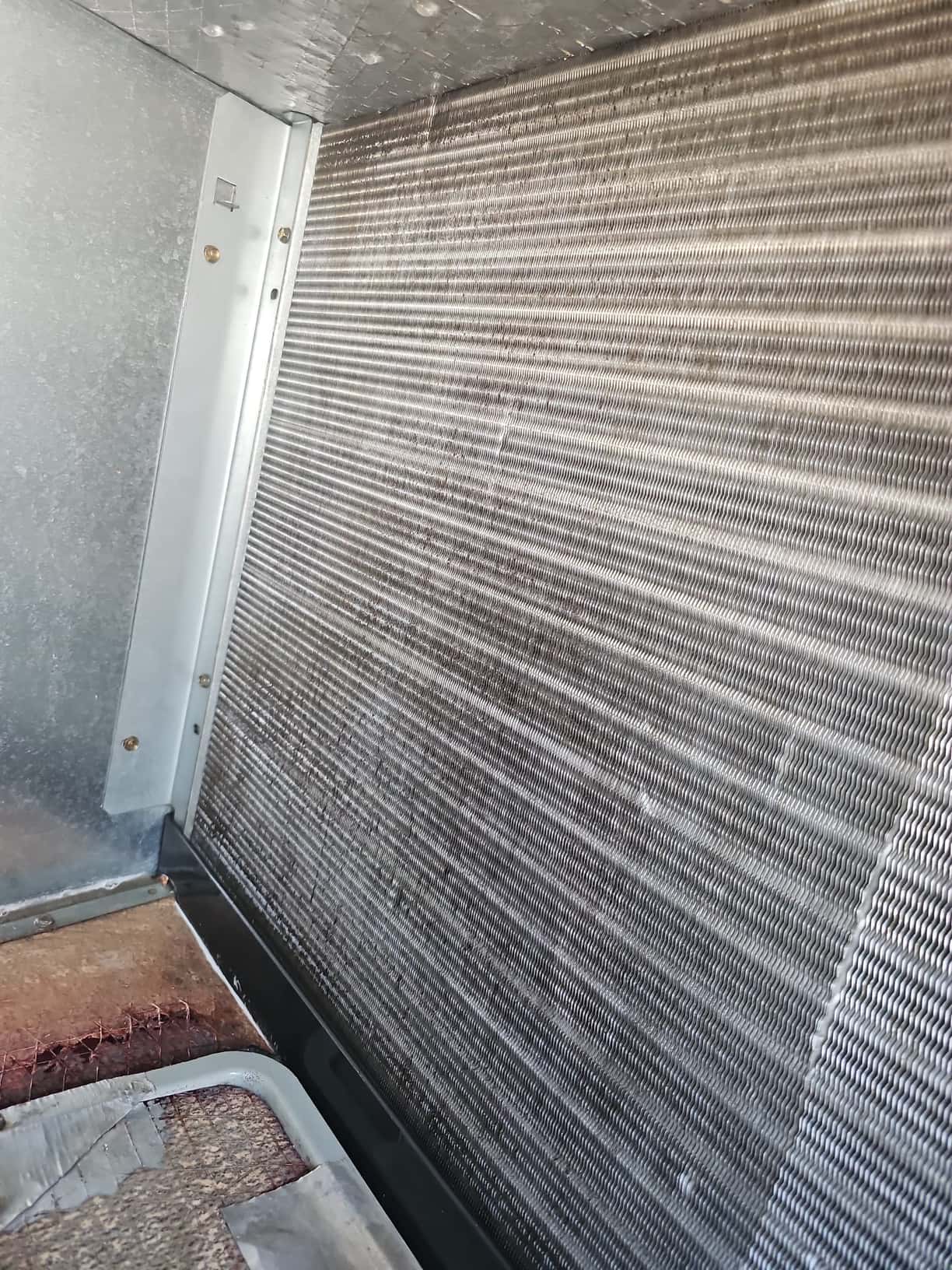 Evaporator coil fins inside an air handler, clean and free of debris after detailed cleaning service.