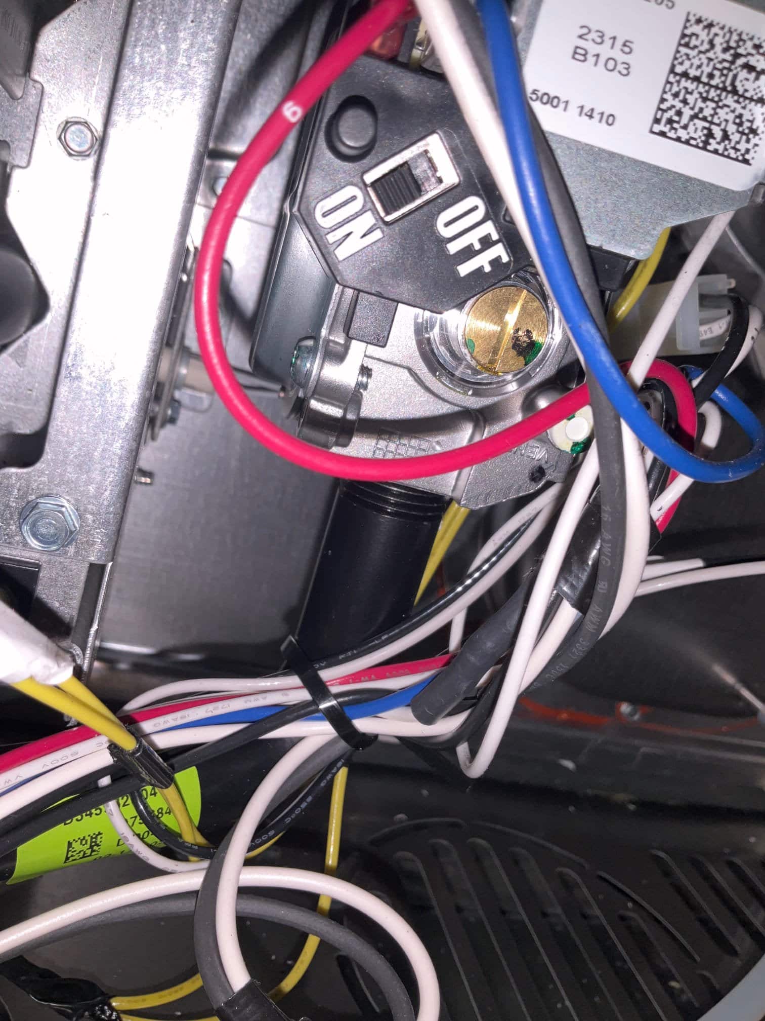 Internal furnace compartment showing control wiring harness and service switch with ON and OFF positions secured inside the cabinet.