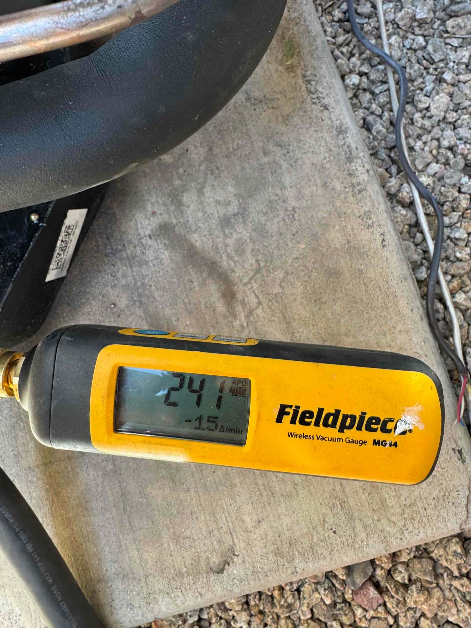 Micron gauge shows 241 microns during evacuation, confirming a deep vacuum on the newly installed system.