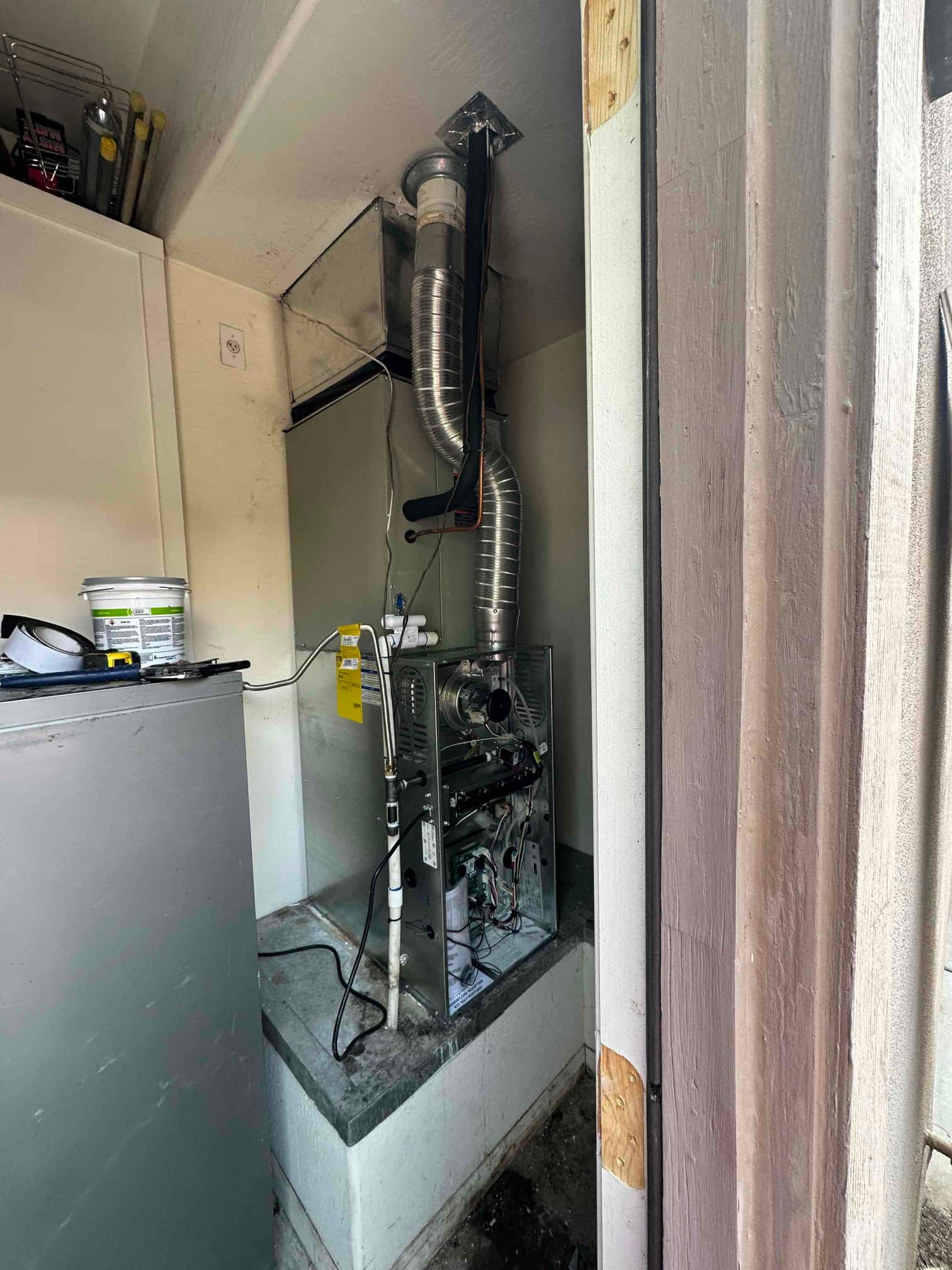 New furnace and evaporator installed on a platform with venting, drain, and electrical connections accessible for commissioning.