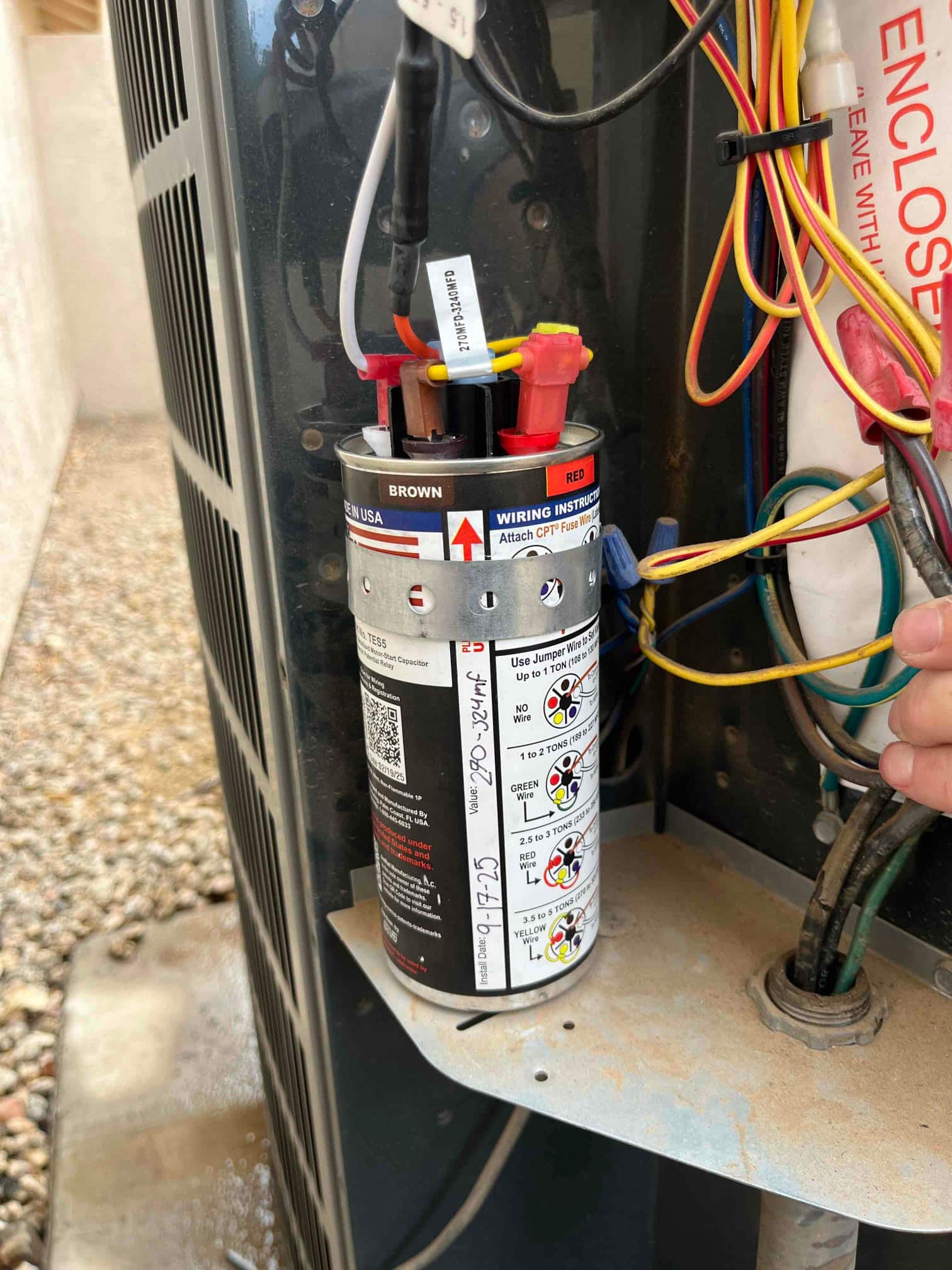 New start assist kit installed on the outdoor condenser, wired to the capacitor and contactor with labeled leads.