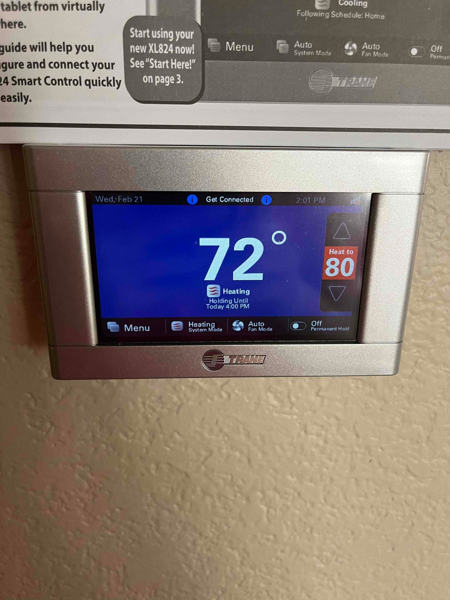 Wall-mounted touchscreen thermostat displays 72 degrees with heating mode active and setpoint at 80.