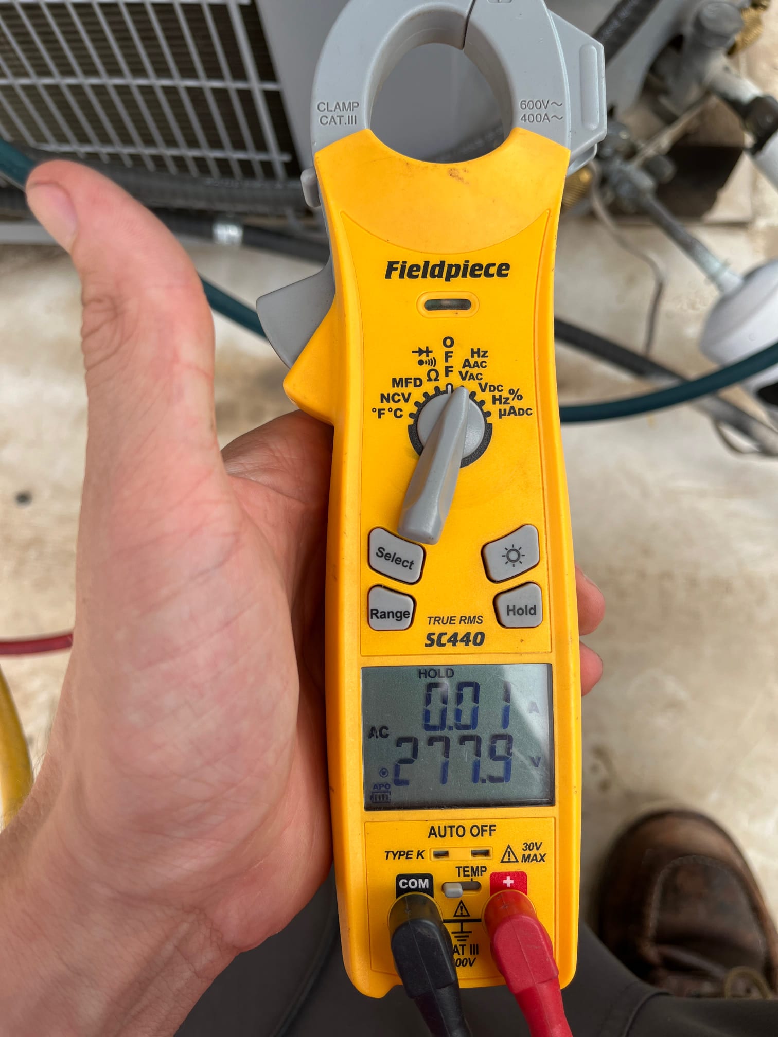 Diagnostic instrument display shows 277.9 V.