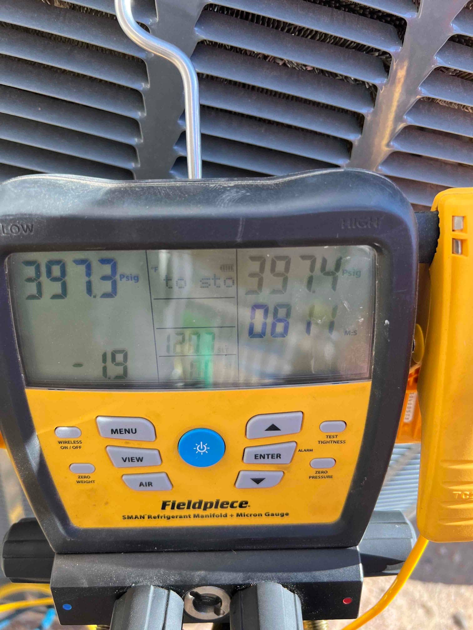 HVAC diagnostic instrument photographed during the service visit.