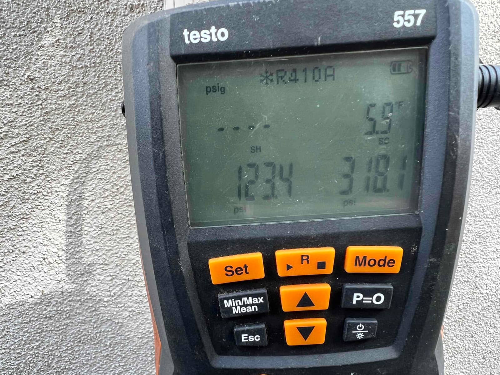HVAC diagnostic instrument photographed during the service visit.