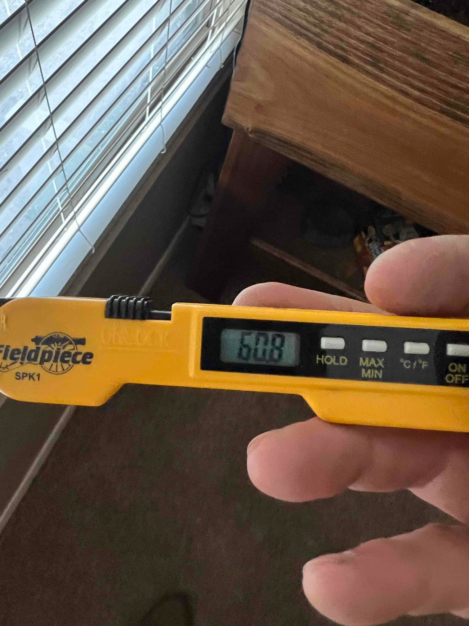 HVAC diagnostic instrument photographed during the service visit.
