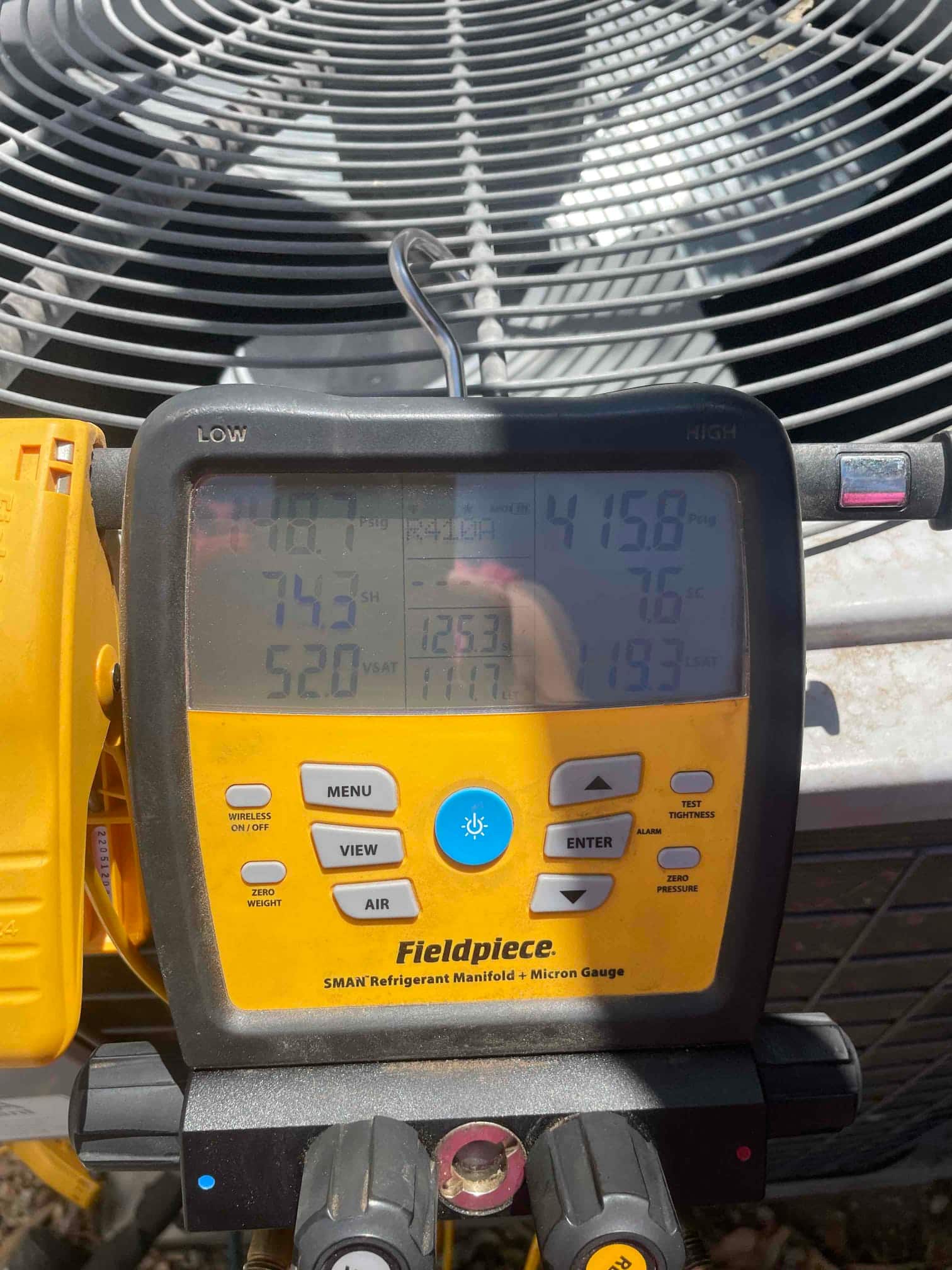 HVAC diagnostic instrument photographed during the service visit.