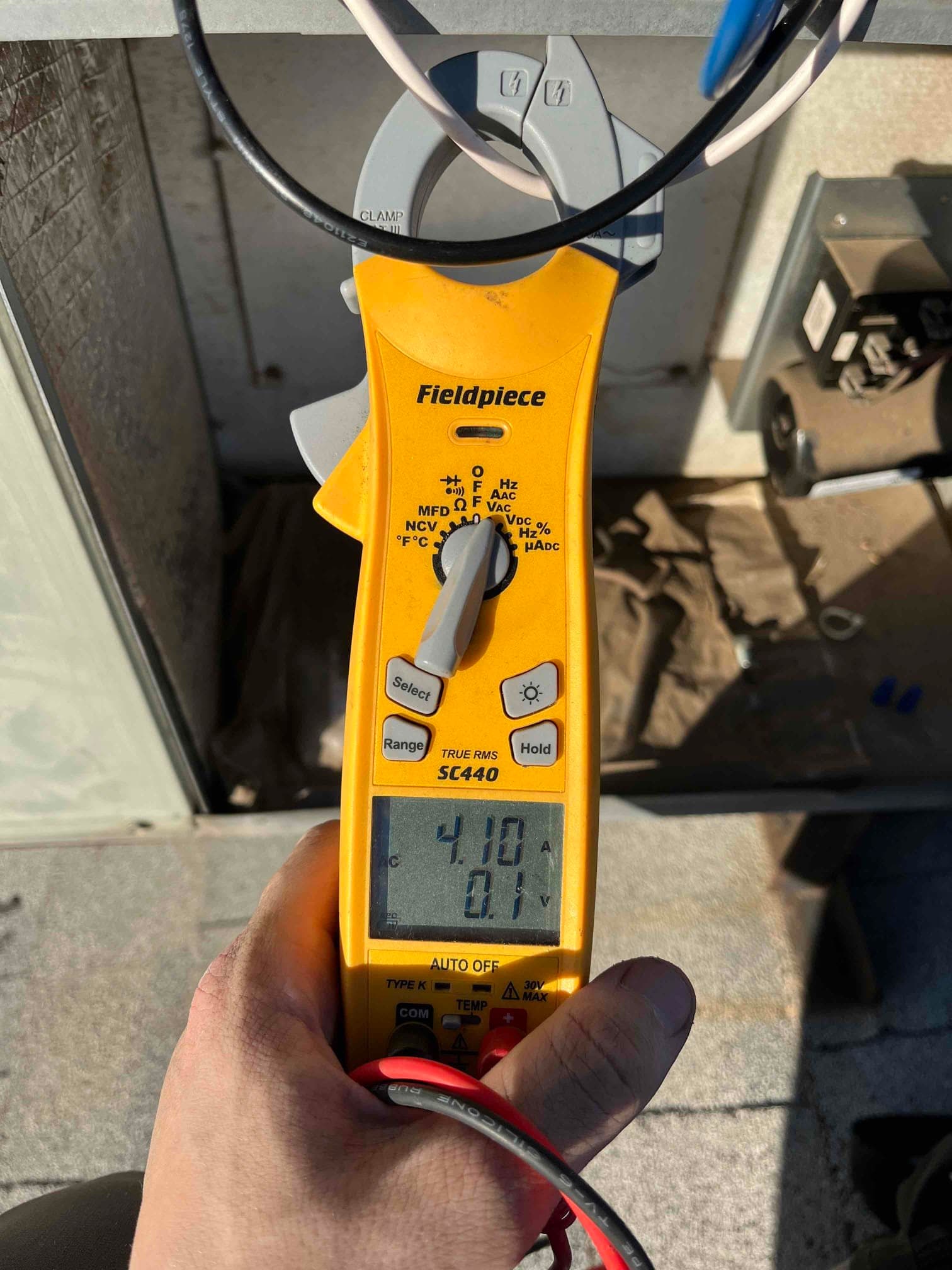 HVAC diagnostic instrument photographed during the service visit.