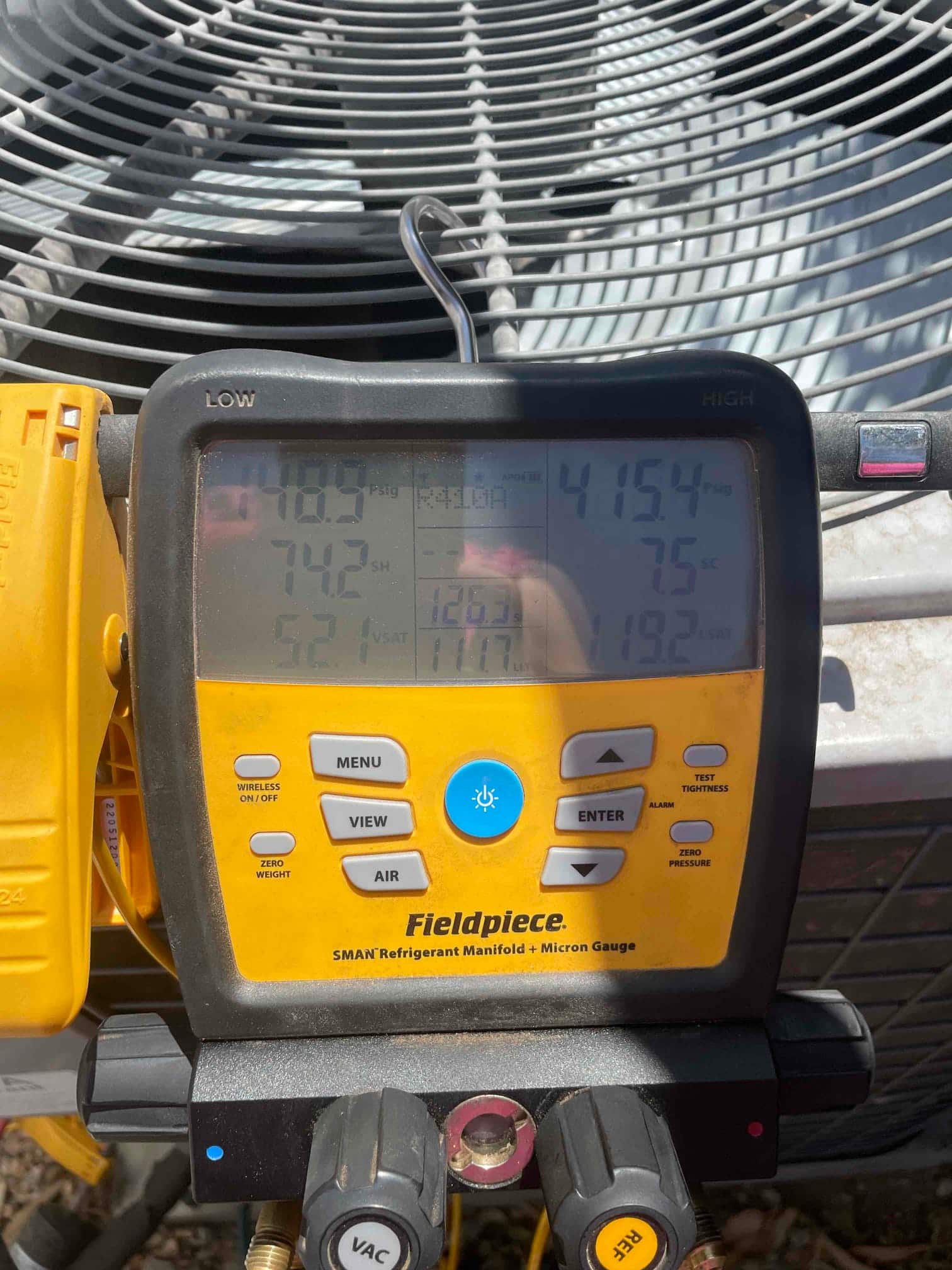 HVAC diagnostic instrument photographed during the service visit.