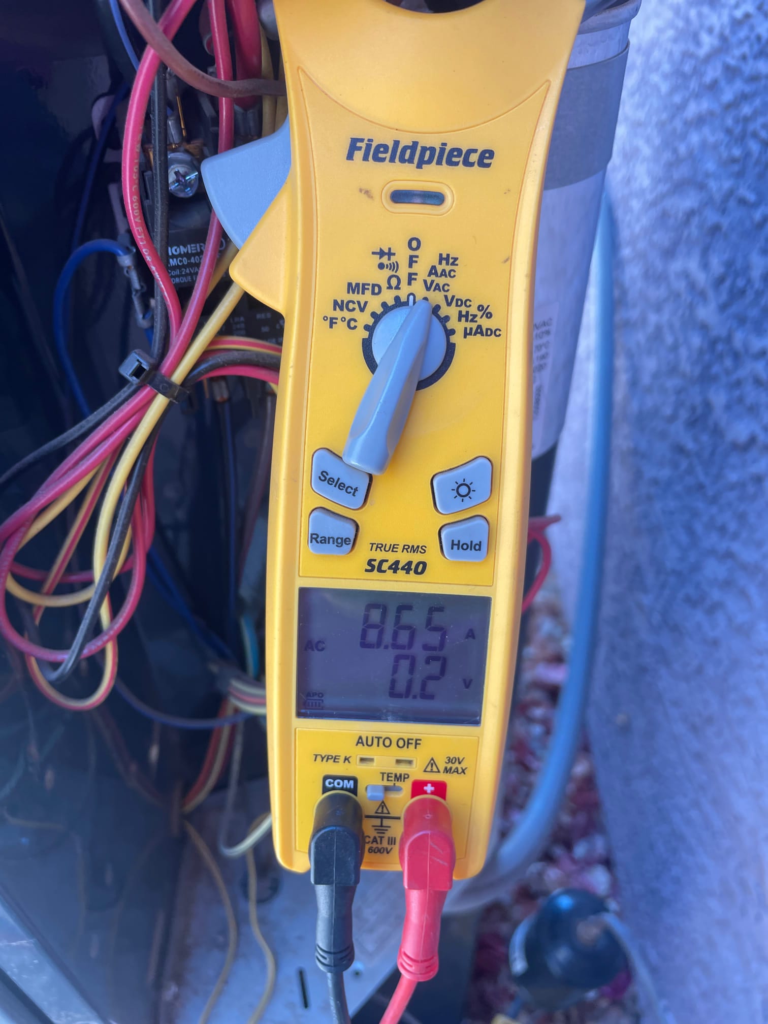 HVAC diagnostic instrument photographed during the service visit.