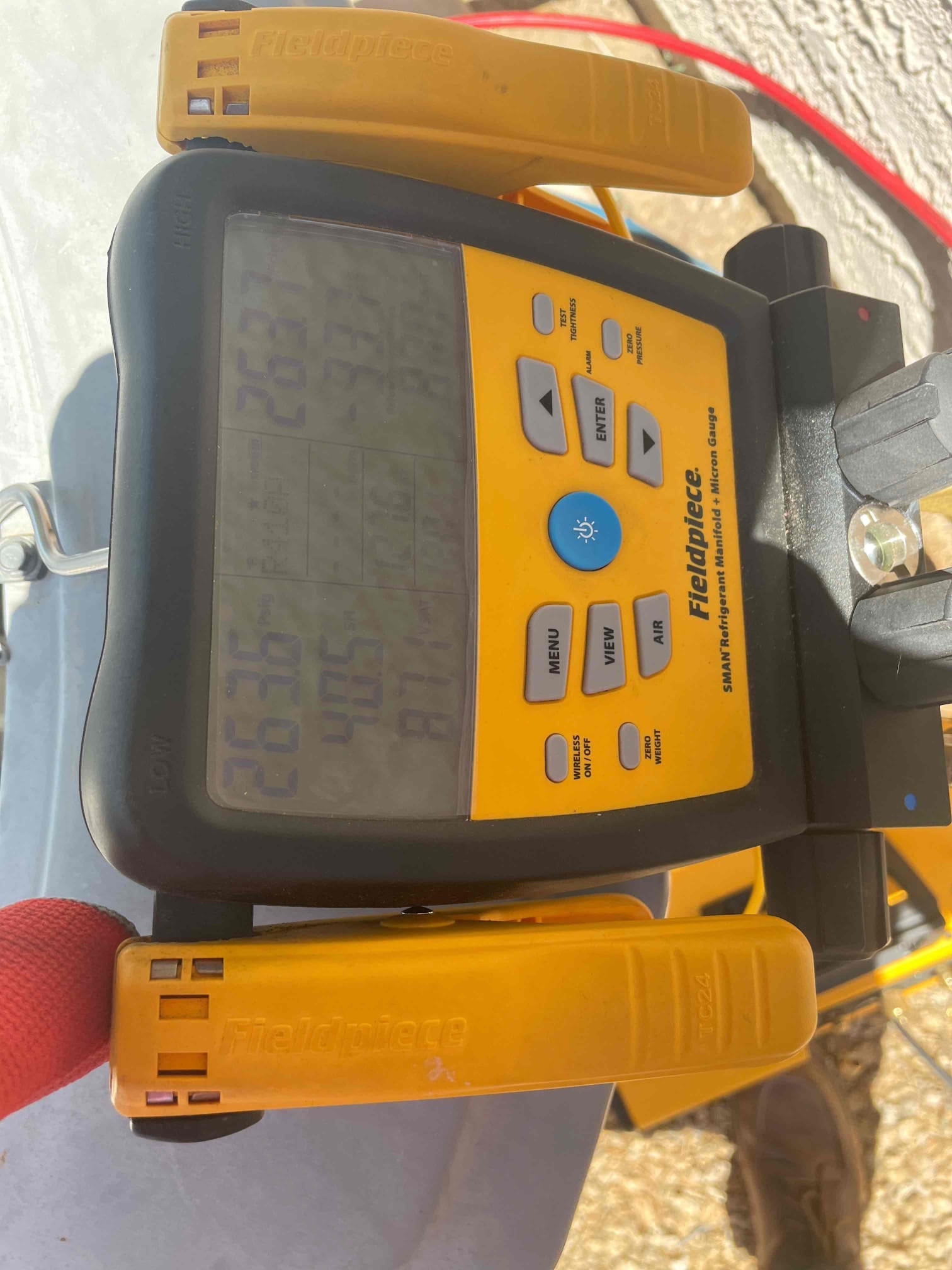 HVAC diagnostic instrument photographed during the service visit.
