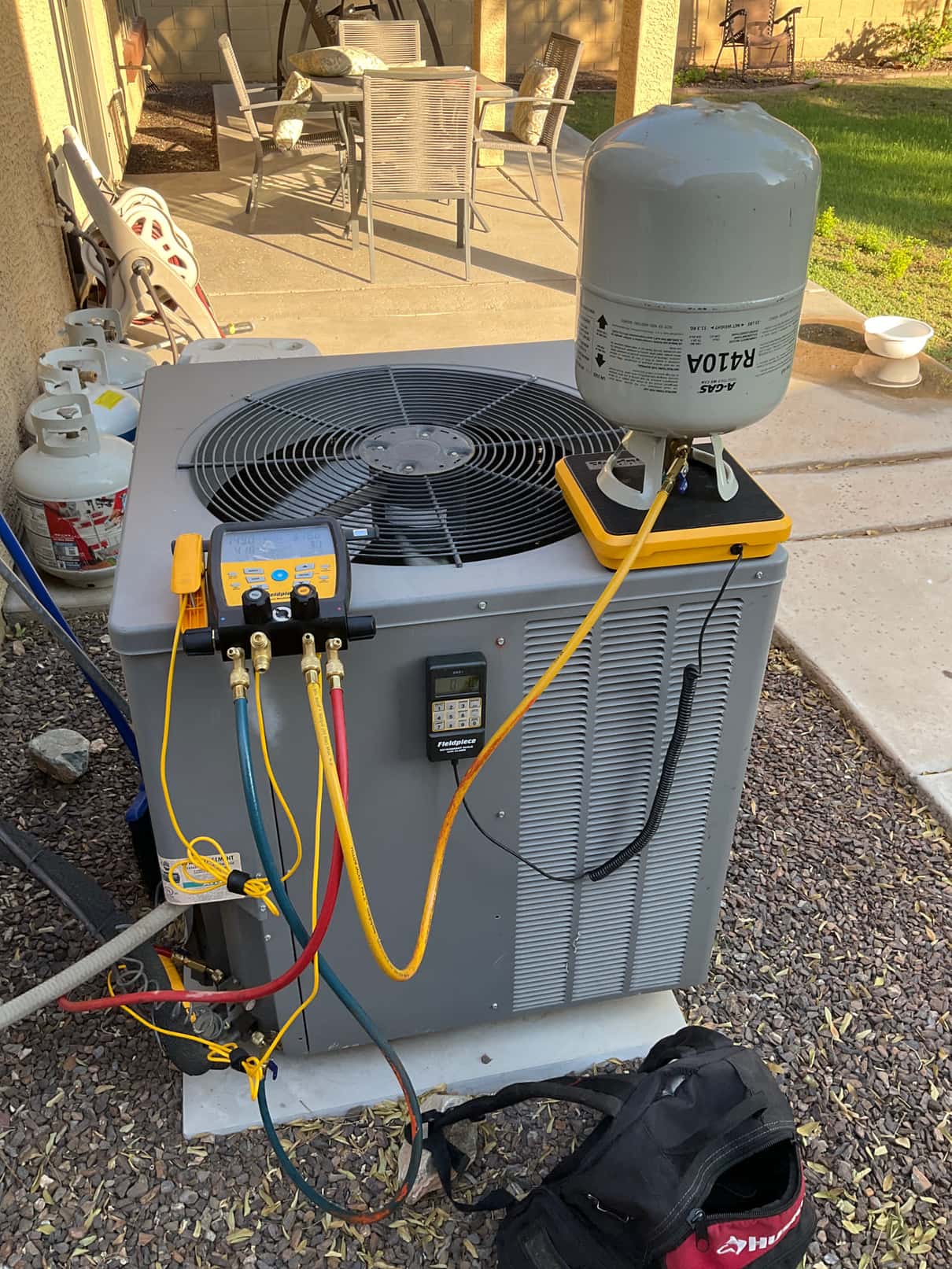 Refrigerant scale photographed during the service visit; no numerical reading is transcribed.