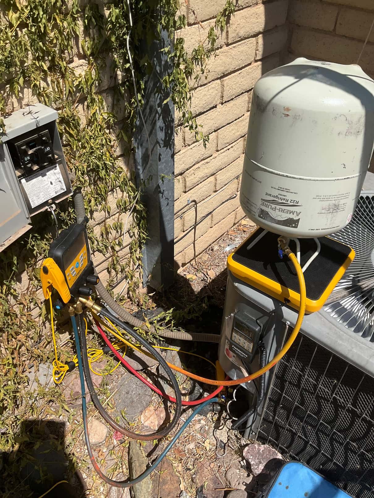 Refrigerant scale photographed during the service visit; no numerical reading is transcribed.