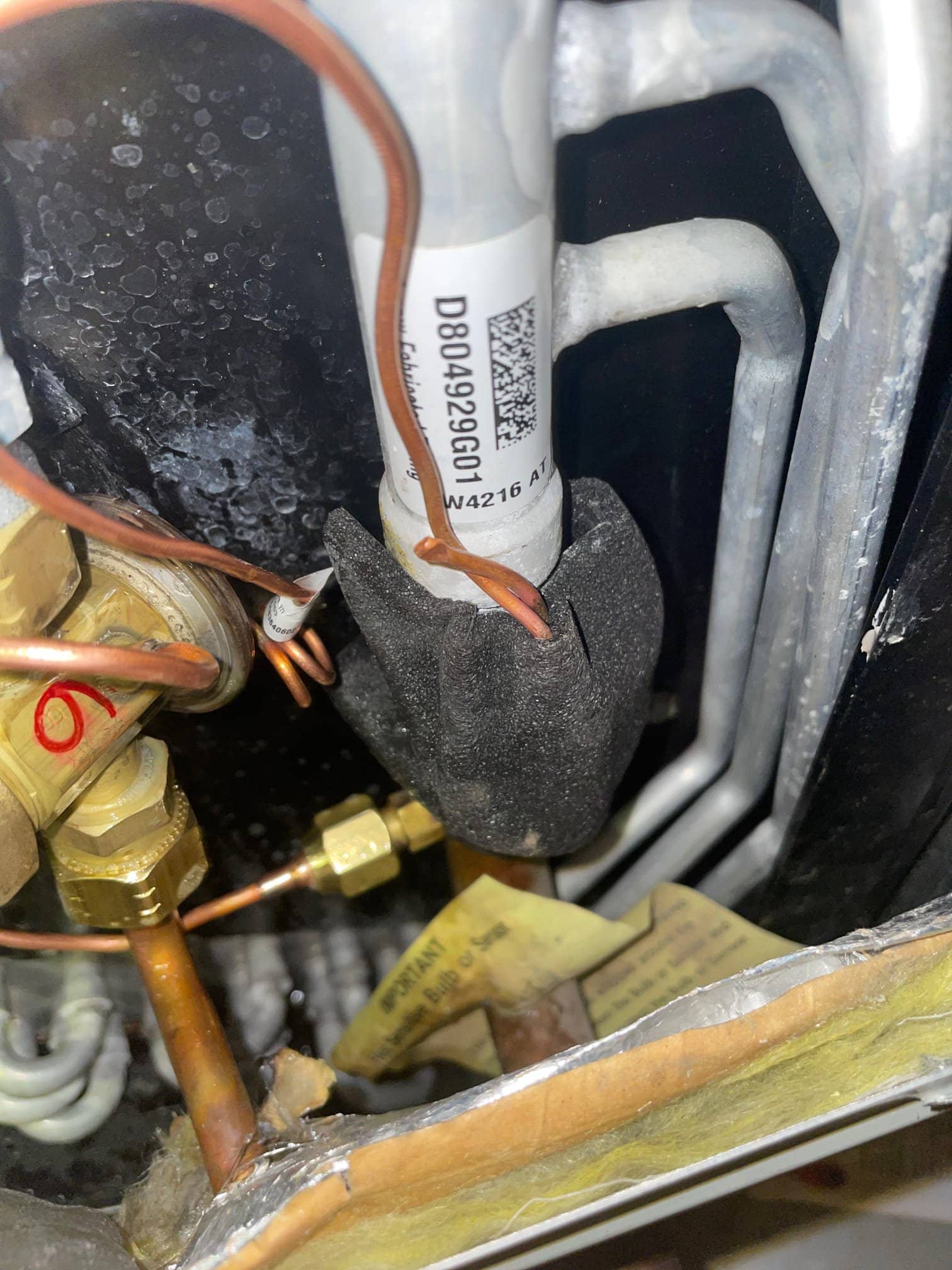Thermal expansion valve assembly with copper capillary and insulated sensing bulb on the suction line inside the unit.