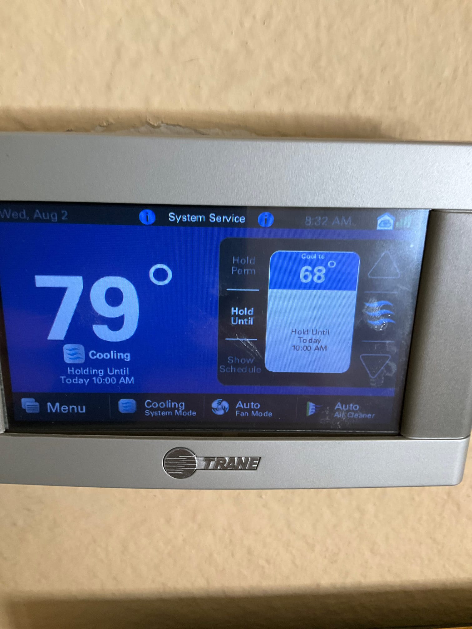 Wall-mounted thermostat display shows 79° indoor temperature with system in cooling mode and setpoint at 68°.