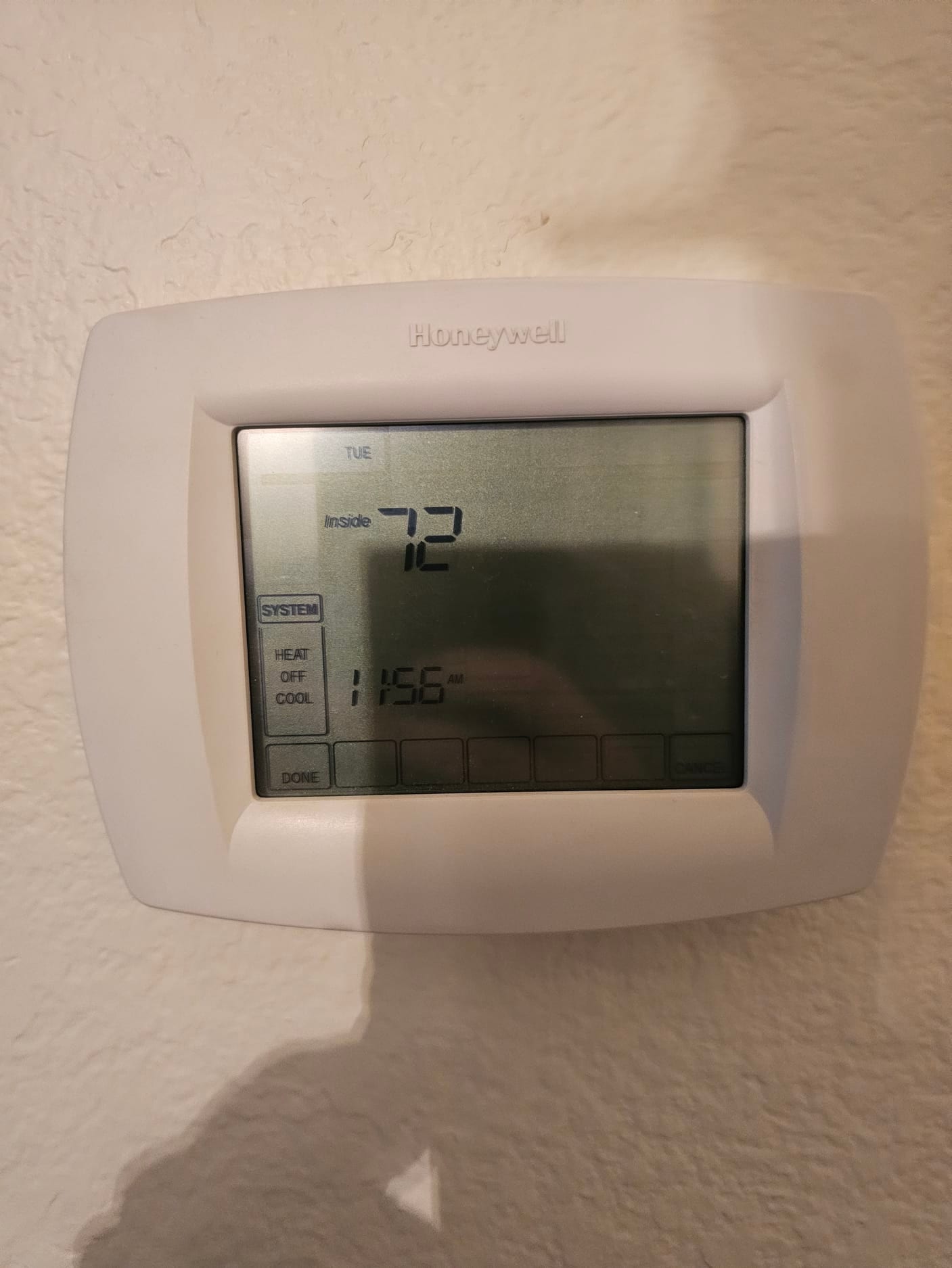 Wall-mounted thermostat displays inside temperature 72 and system mode selection buttons for heat, off, and cool.