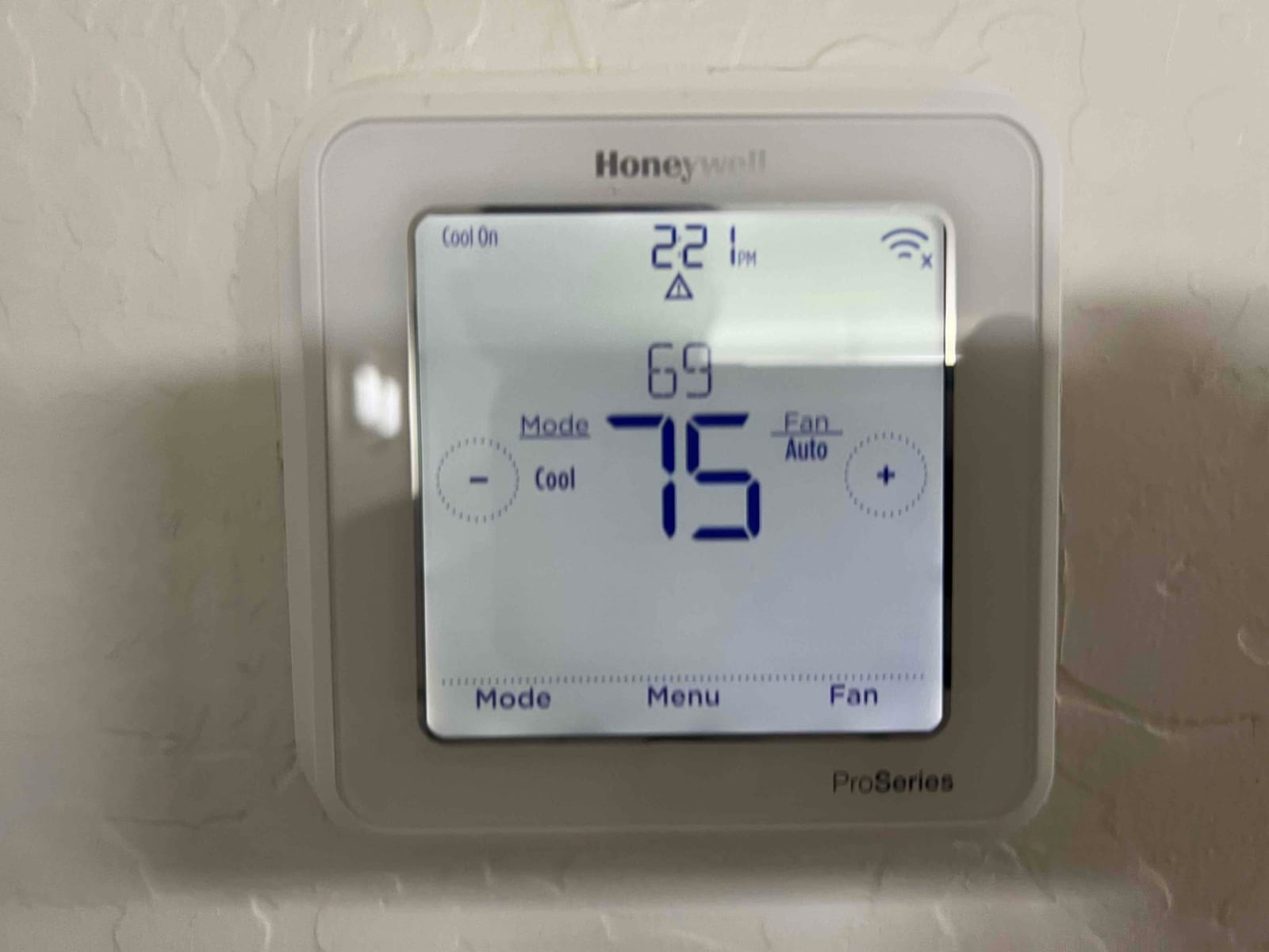Wall-mounted thermostat shows Cool On, set to 75°F with room temperature 69°F, fan Auto, time 2:21 PM.