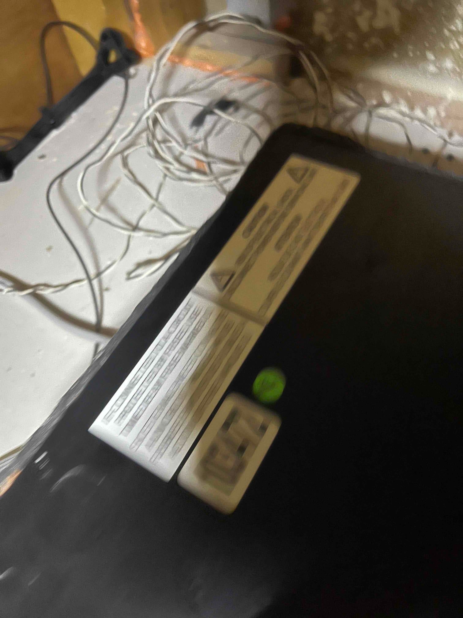 Air handler cabinet with wiring visible nearby during installation, showing safety and information labels on the unit exterior.