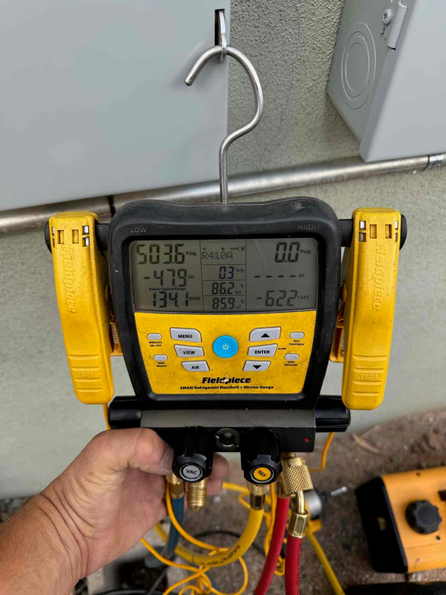 Digital manifold gauges show equalized pressure around 503 PSI on both sides during a nitrogen pressure test of the new system.
