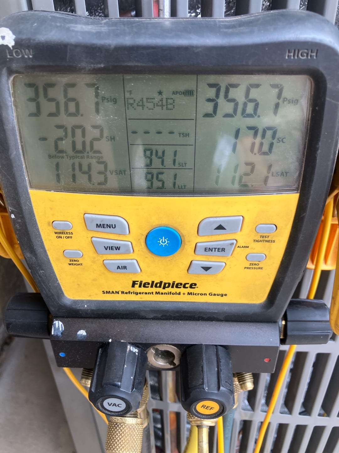 Digital manifold shows both high and low sides at 356.7 PSI during a nitrogen pressure test on the newly installed system.