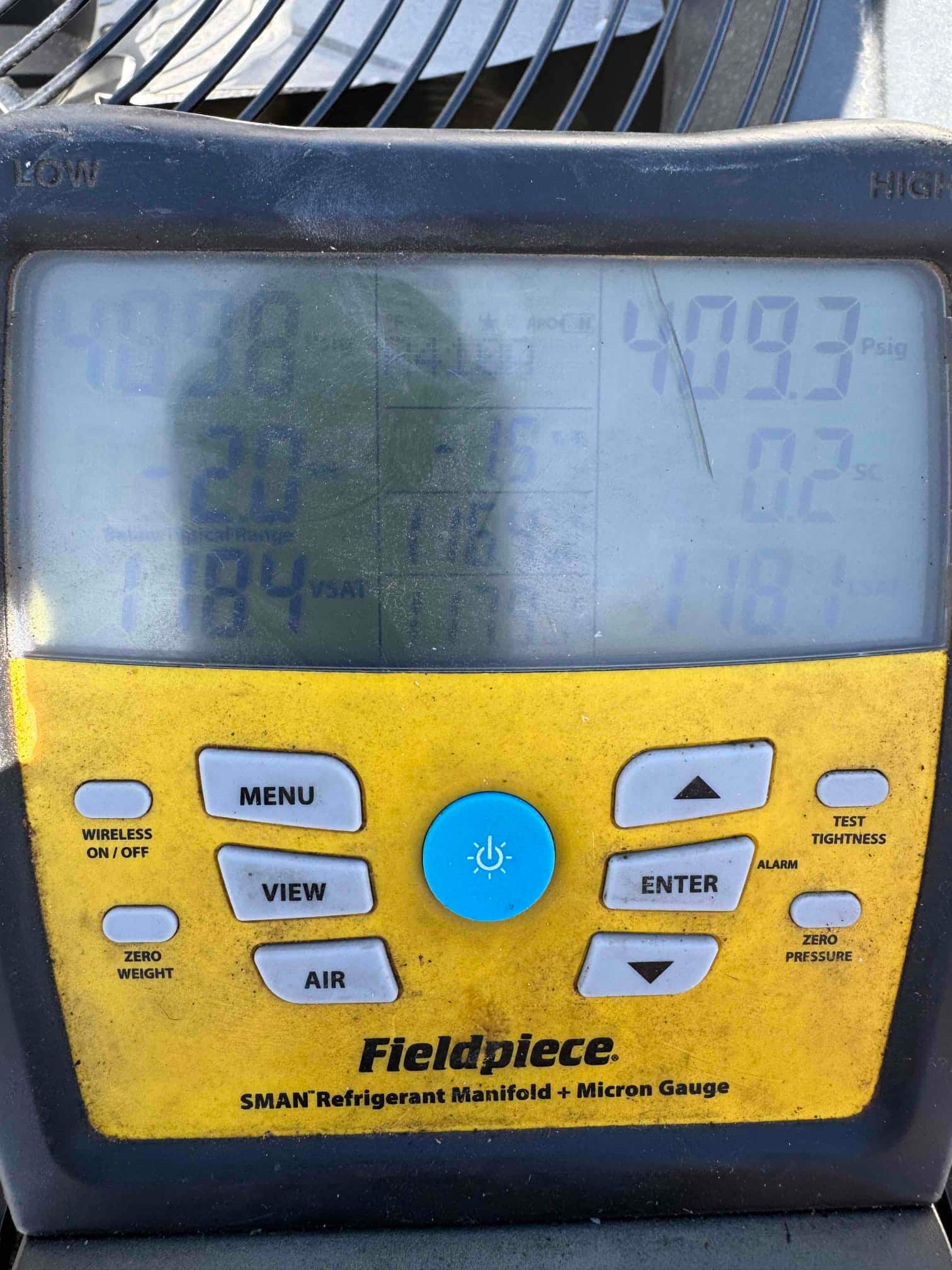 Digital manifold shows both low and high sides holding around 409 PSI, documenting a nitrogen pressure test on the new system.
