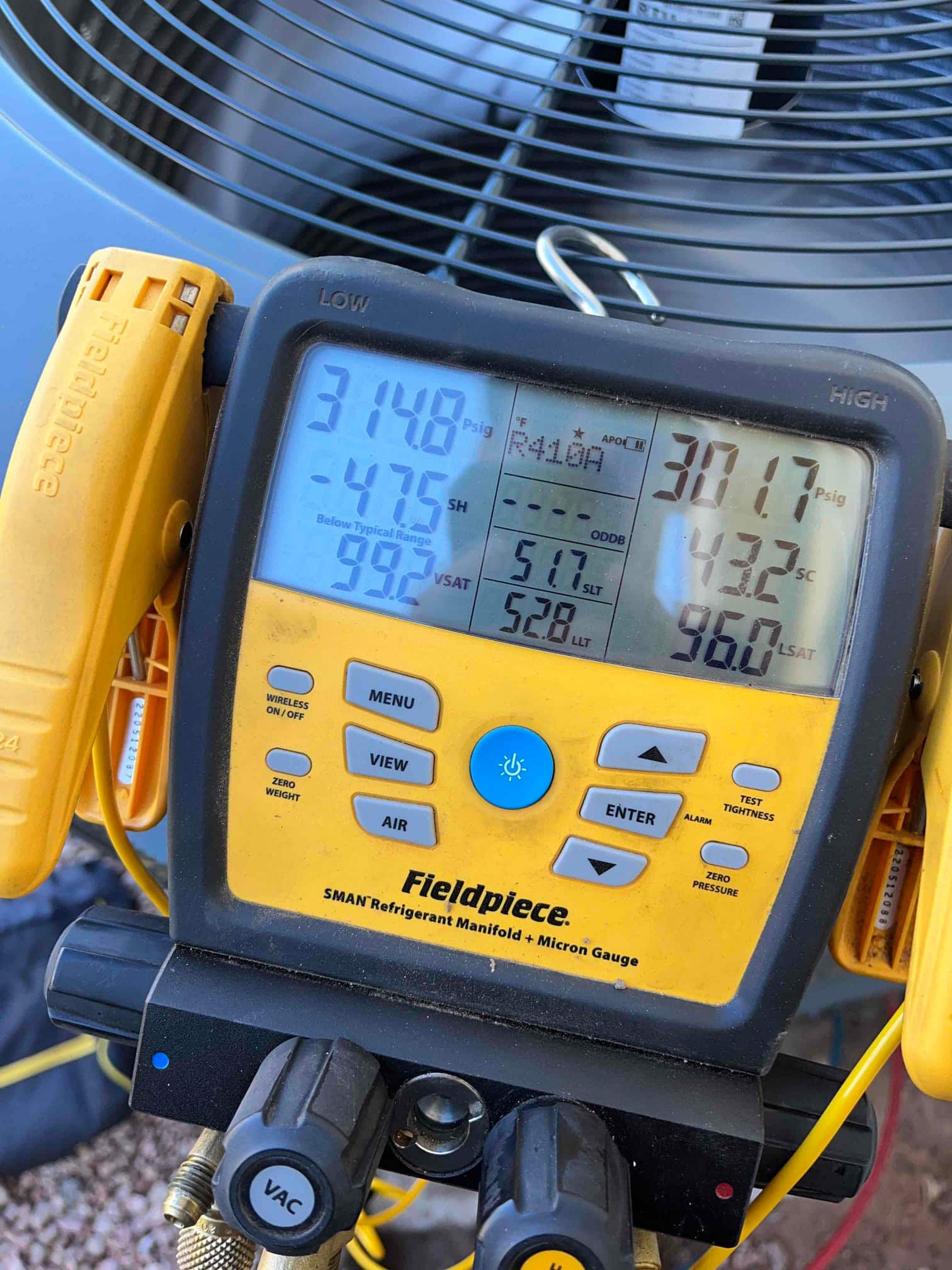 Digital manifold shows system operating with low side at 148 PSI and high side at 317 PSI on R-410A refrigerant.