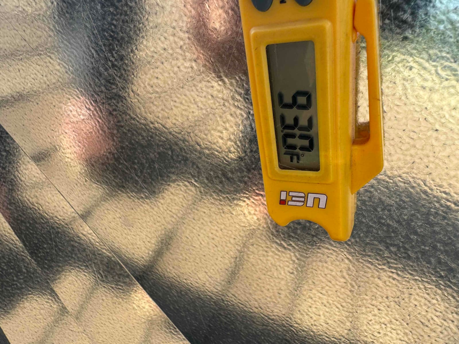 Digital thermometer reading 93.0°F on duct surface during air-side temperature check.