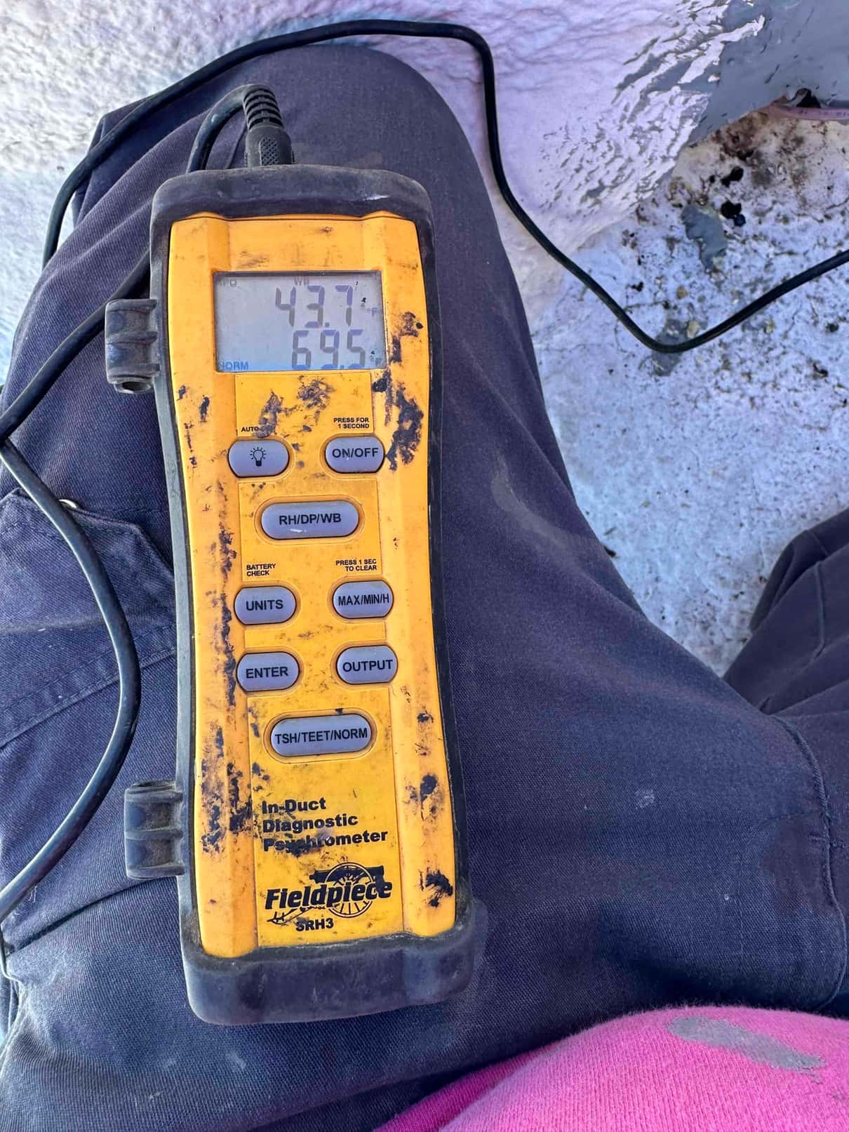 Digital thermometer reads 43.7°F and 69.5°F during air temperature checks with the probe lead connected.