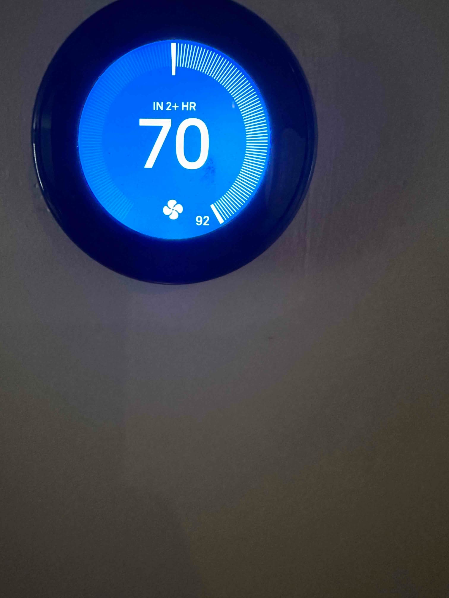 Wall-mounted smart thermostat displays a 70-degree cooling setpoint with fan icon and remaining time indicator.
