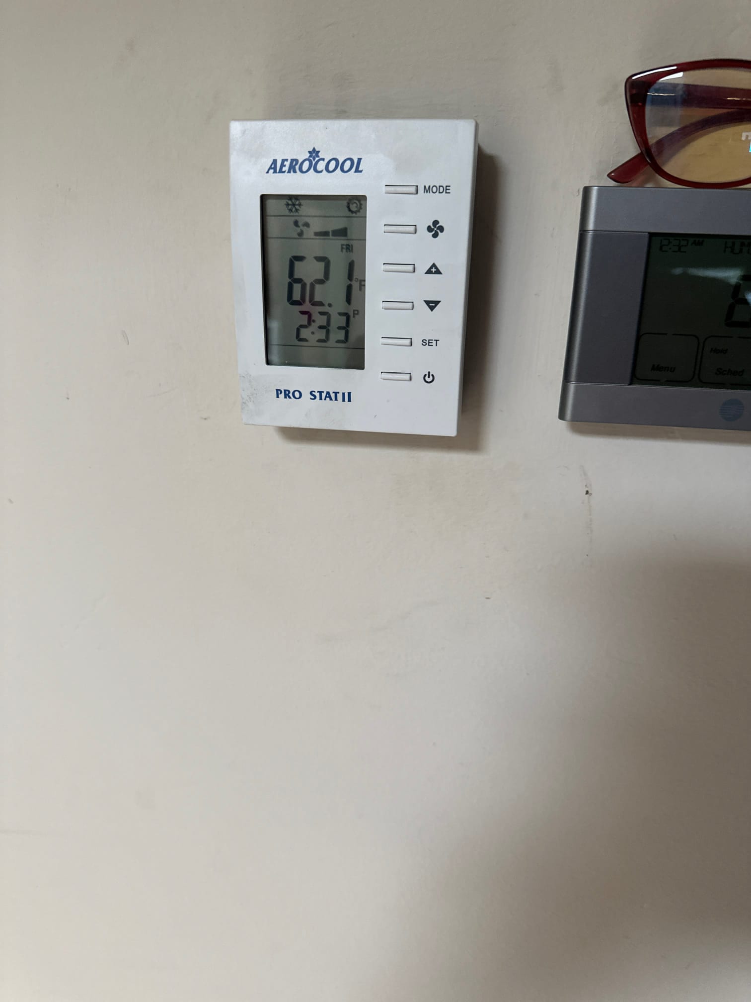 Wall-mounted thermostat displays 62.1°F with cooling mode active during system check.