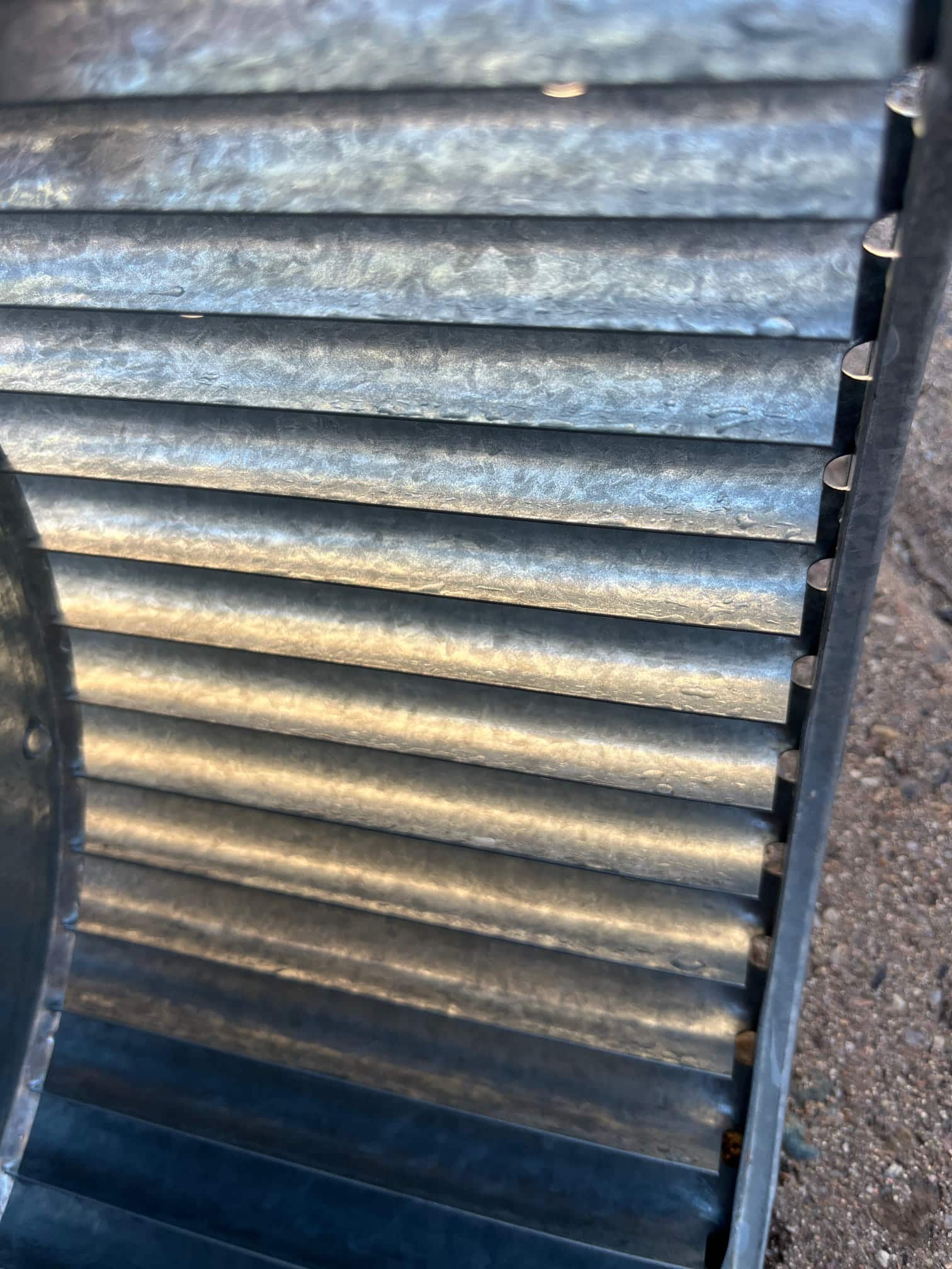 Close-up of a metal HVAC blower wheel with clean, evenly spaced blades after detailed cleaning.
