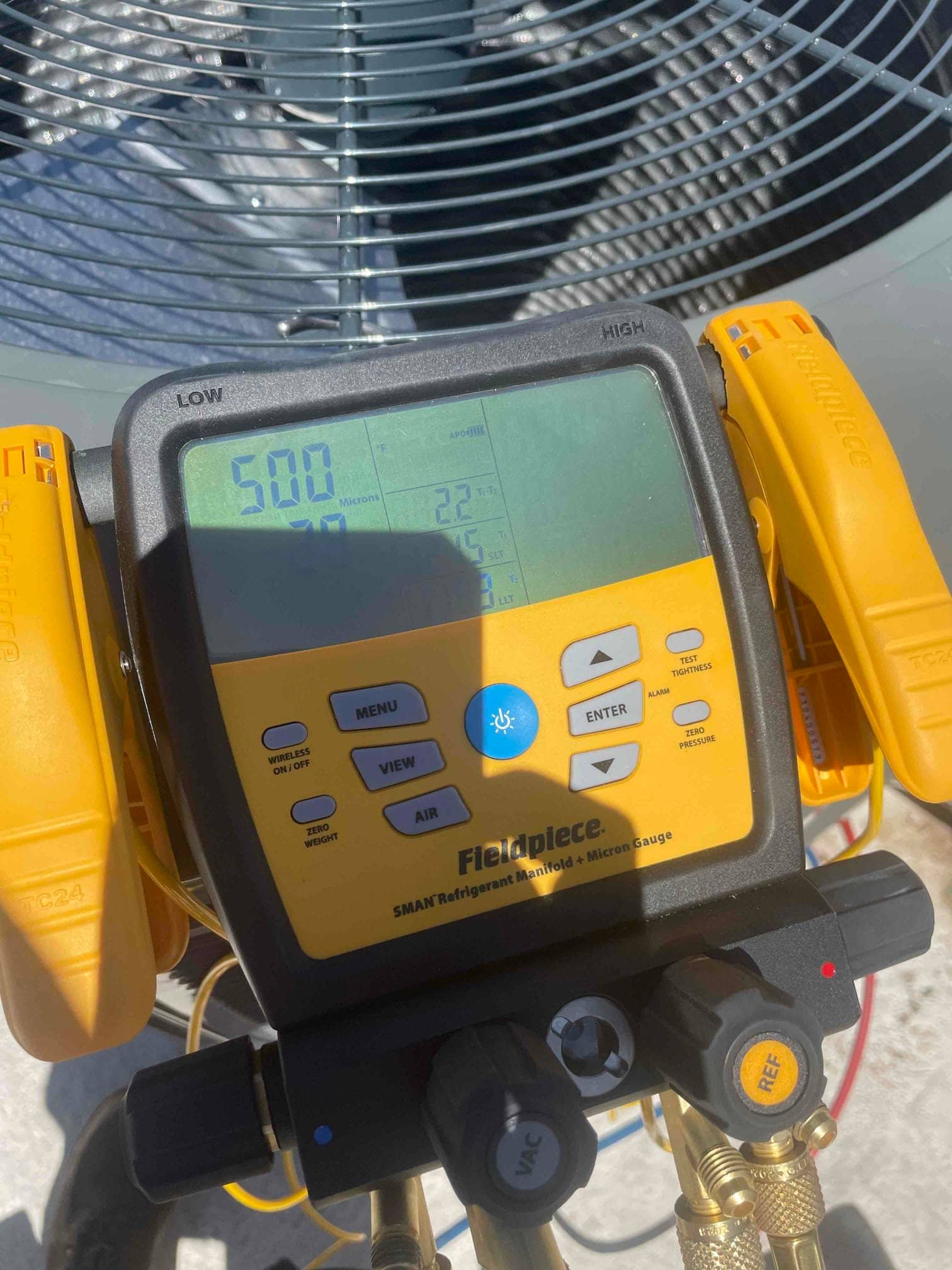 Digital manifold gauges show equal pressure at 500 PSI on both sides during a nitrogen pressure test of the system.