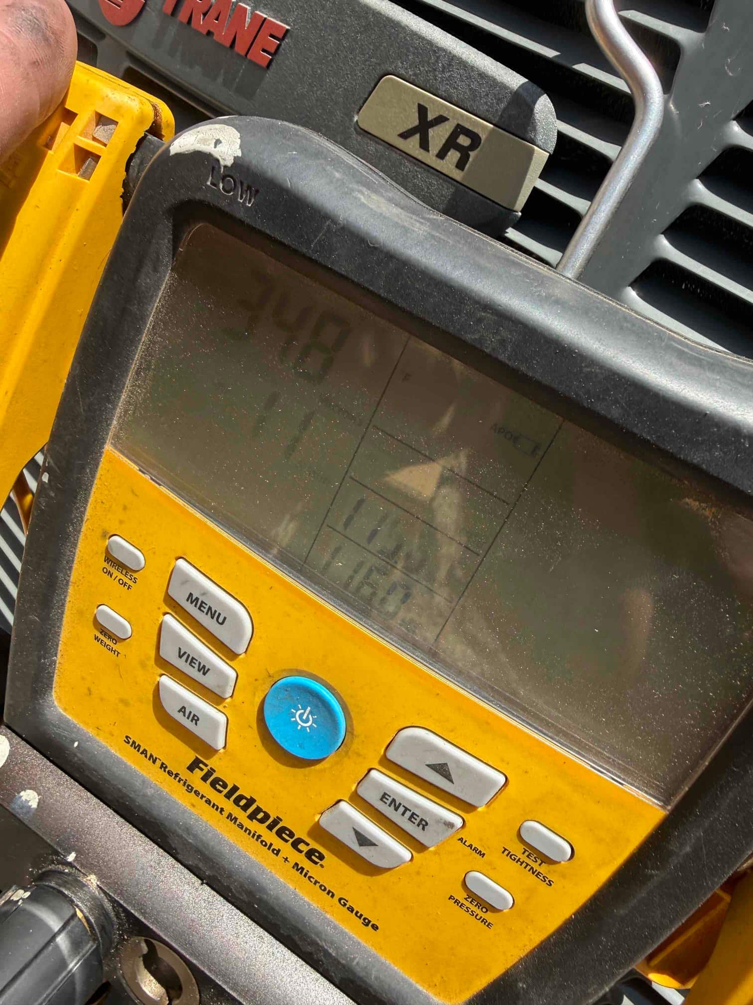 Digital manifold shows equal high pressure on both sides during a nitrogen pressure test at the outdoor condenser.