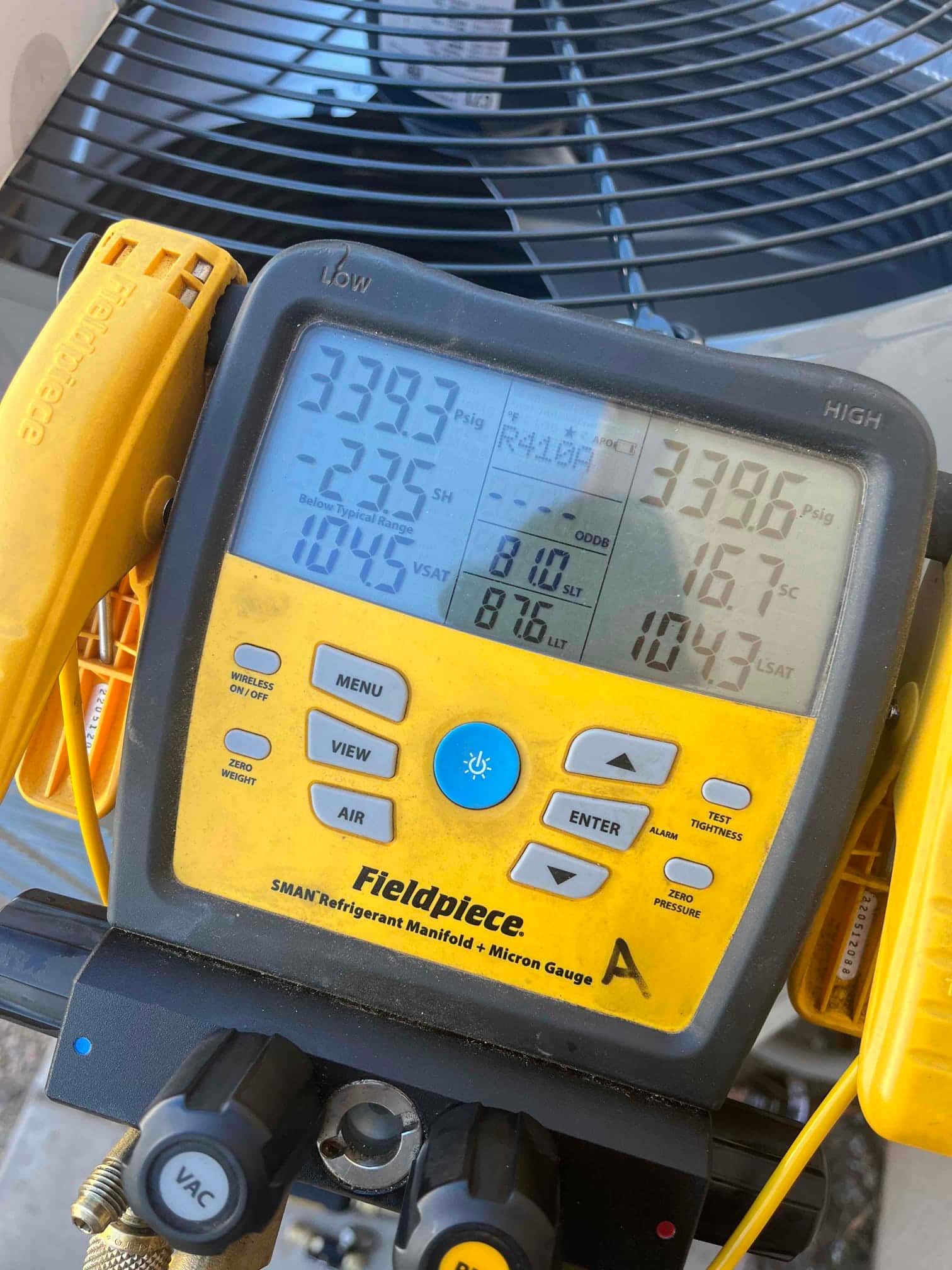 Digital manifold shows equal pressures around 339 PSI on both sides during a nitrogen pressure test at the outdoor condenser.