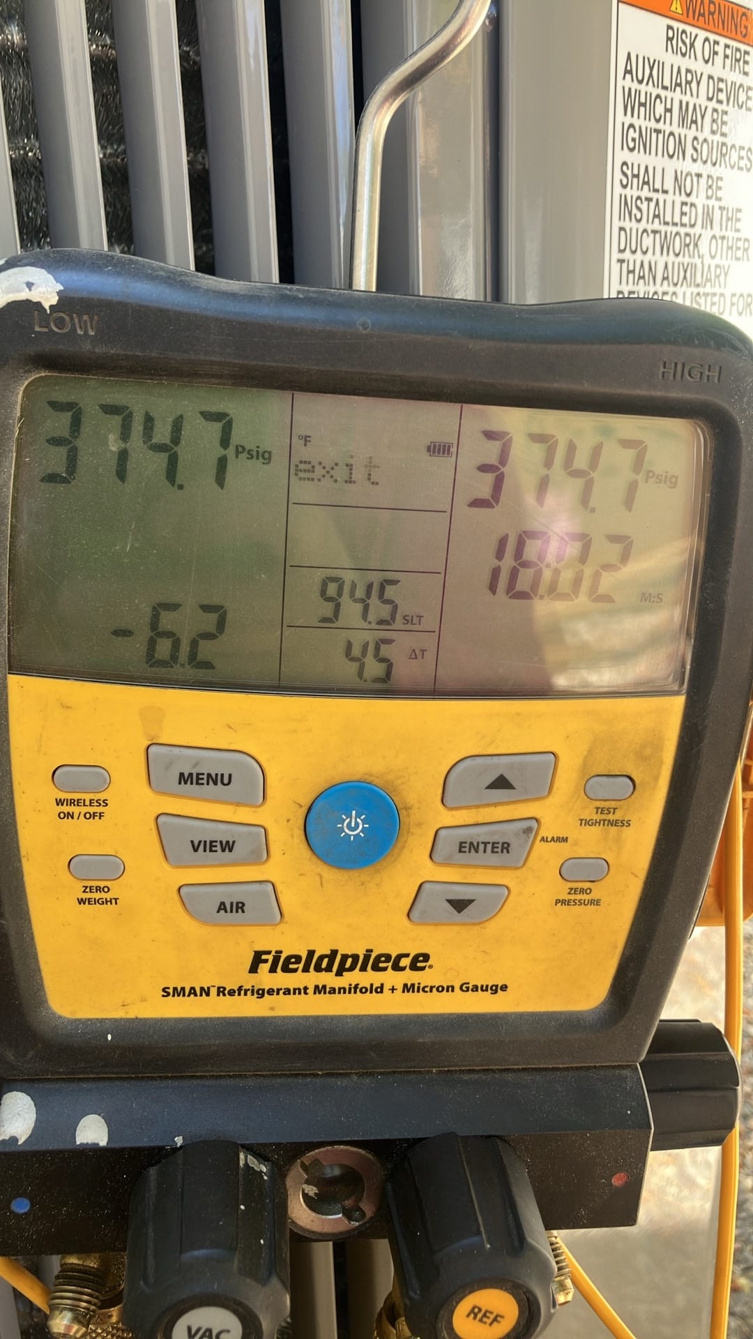 Digital manifold shows both high and low sides holding 374.7 PSI during the nitrogen pressure test on the new system.