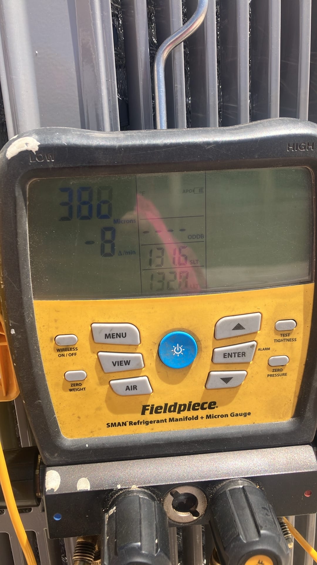 Digital micron gauge on the manifold shows 388 microns with a change rate of -8 microns per minute during system evacuation.