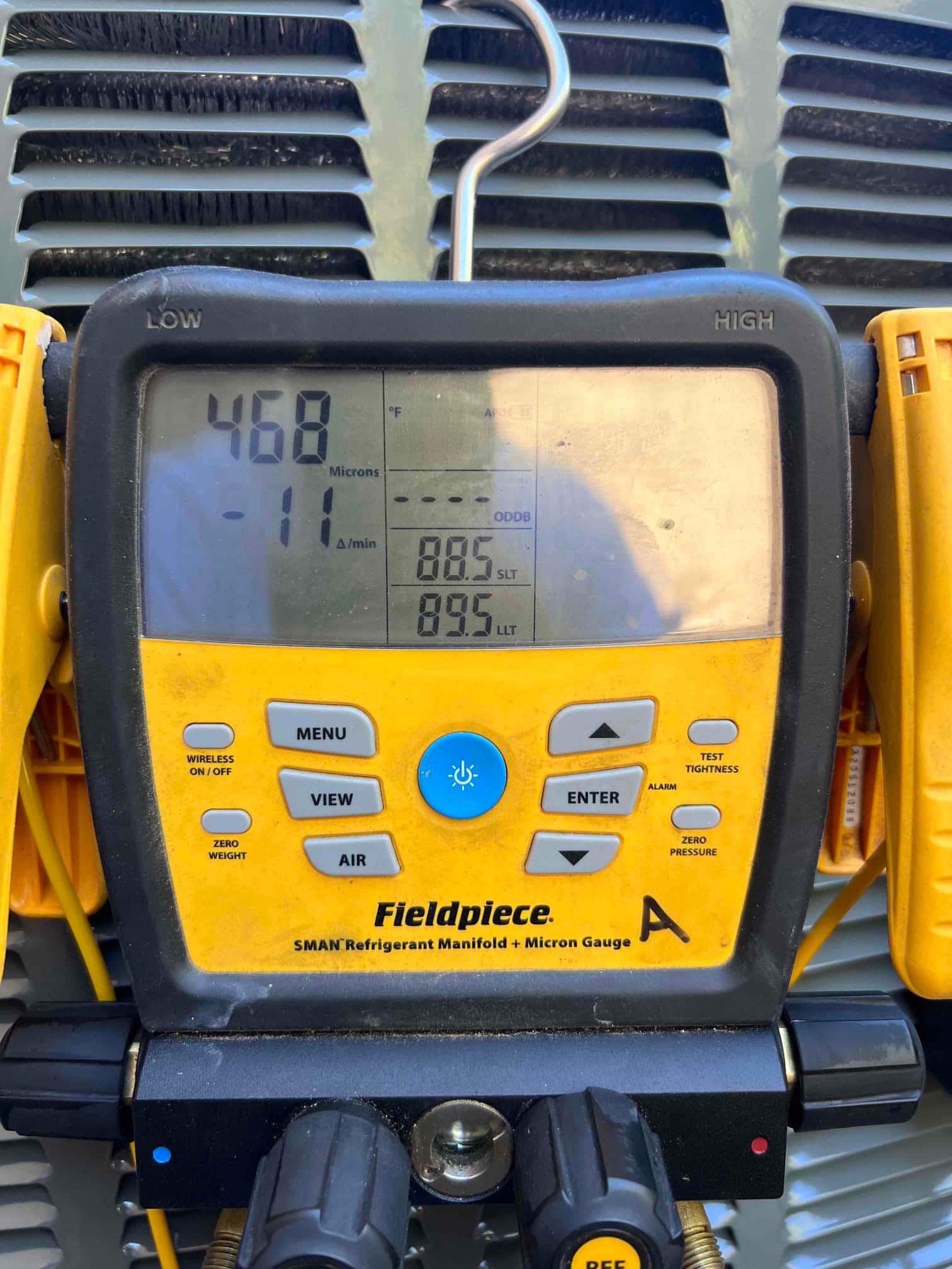 Digital micron gauge on the system displays 468 microns during evacuation, confirming a deep vacuum before refrigerant charging.