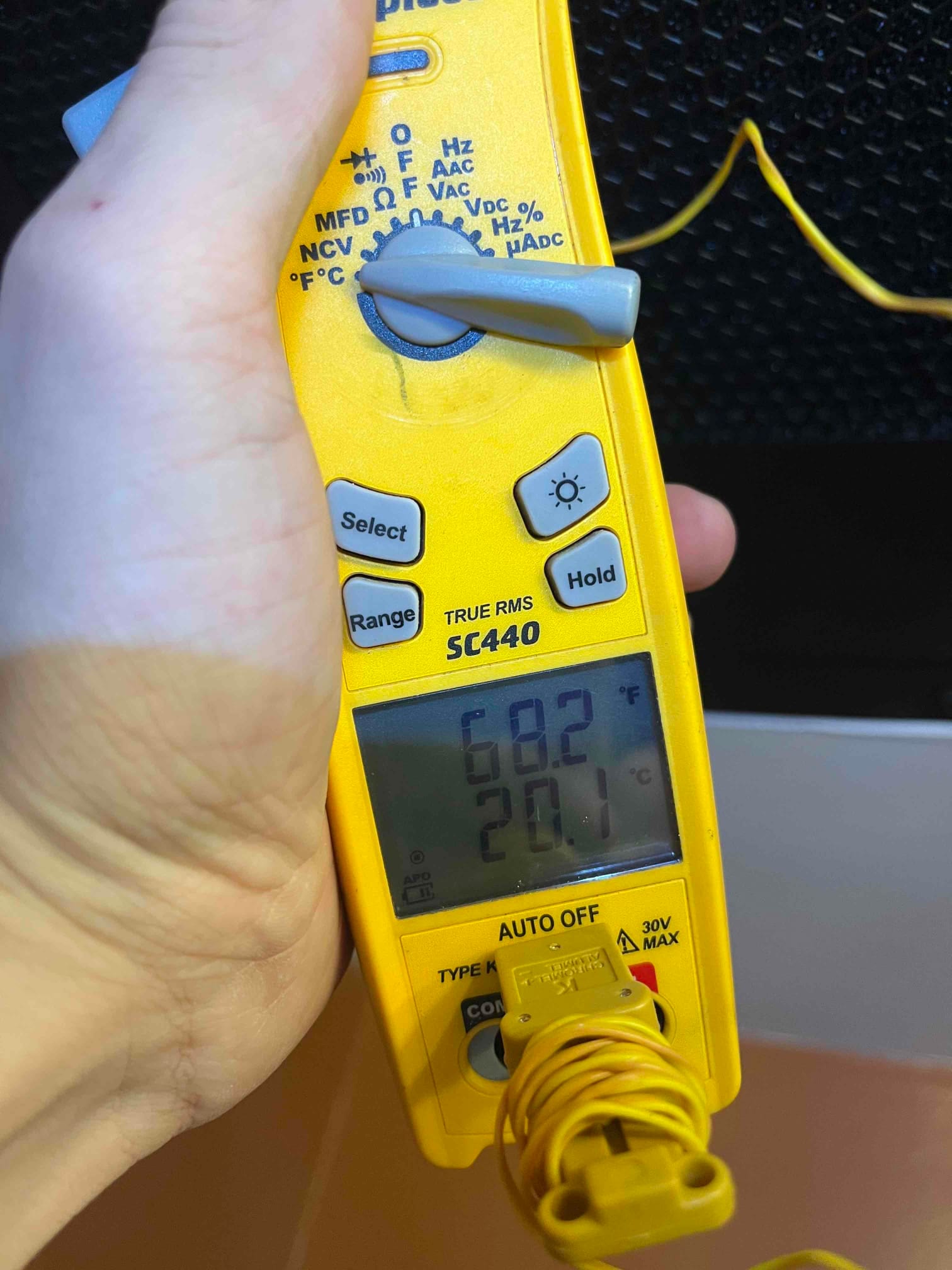 Digital thermometer with type K probe shows 68.2 degrees Fahrenheit, documenting an air temperature reading during commissioning.