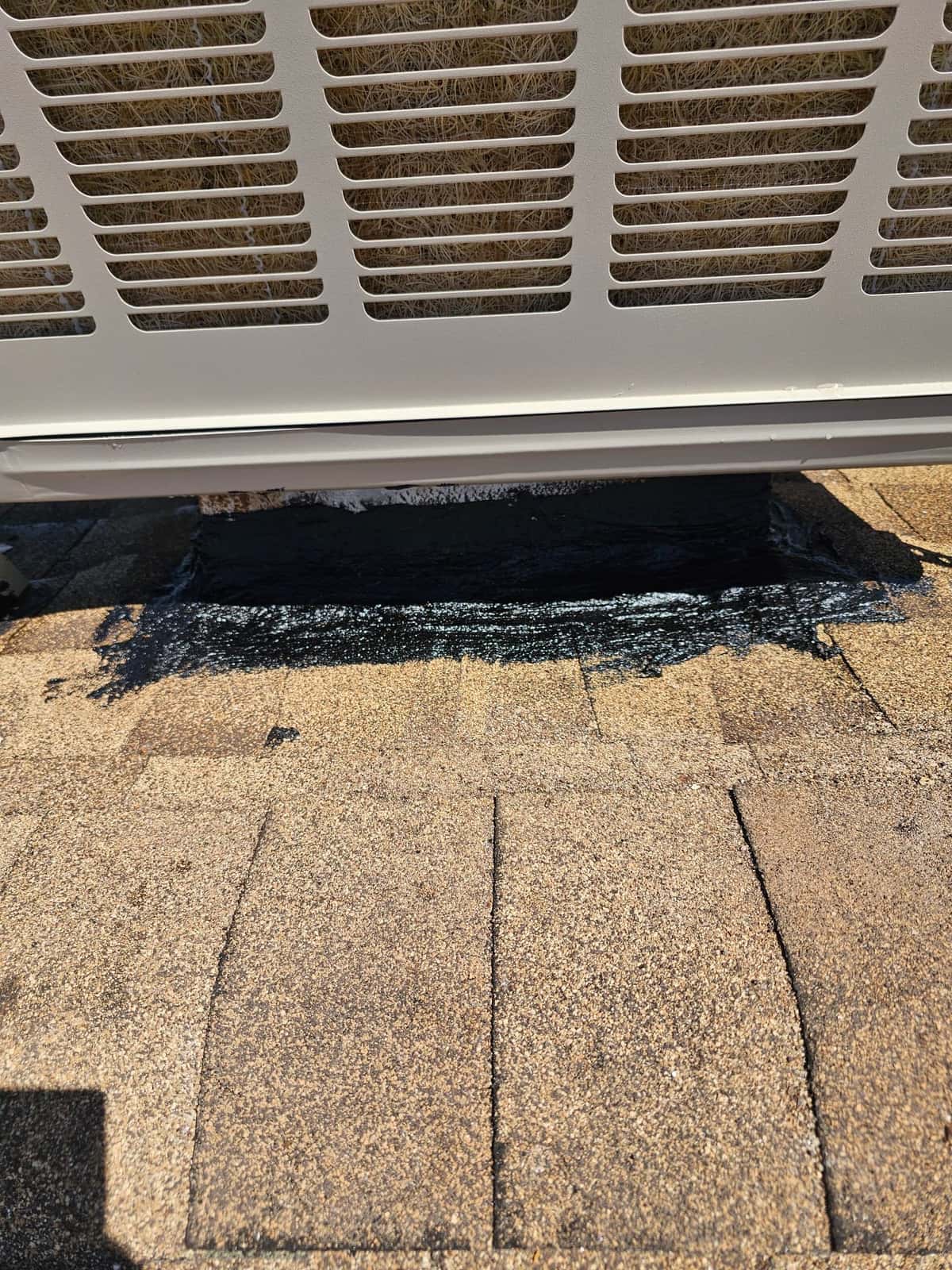 Evaporative cooler base set and roof penetration sealed with roofing mastic on asphalt shingles for weather protection.