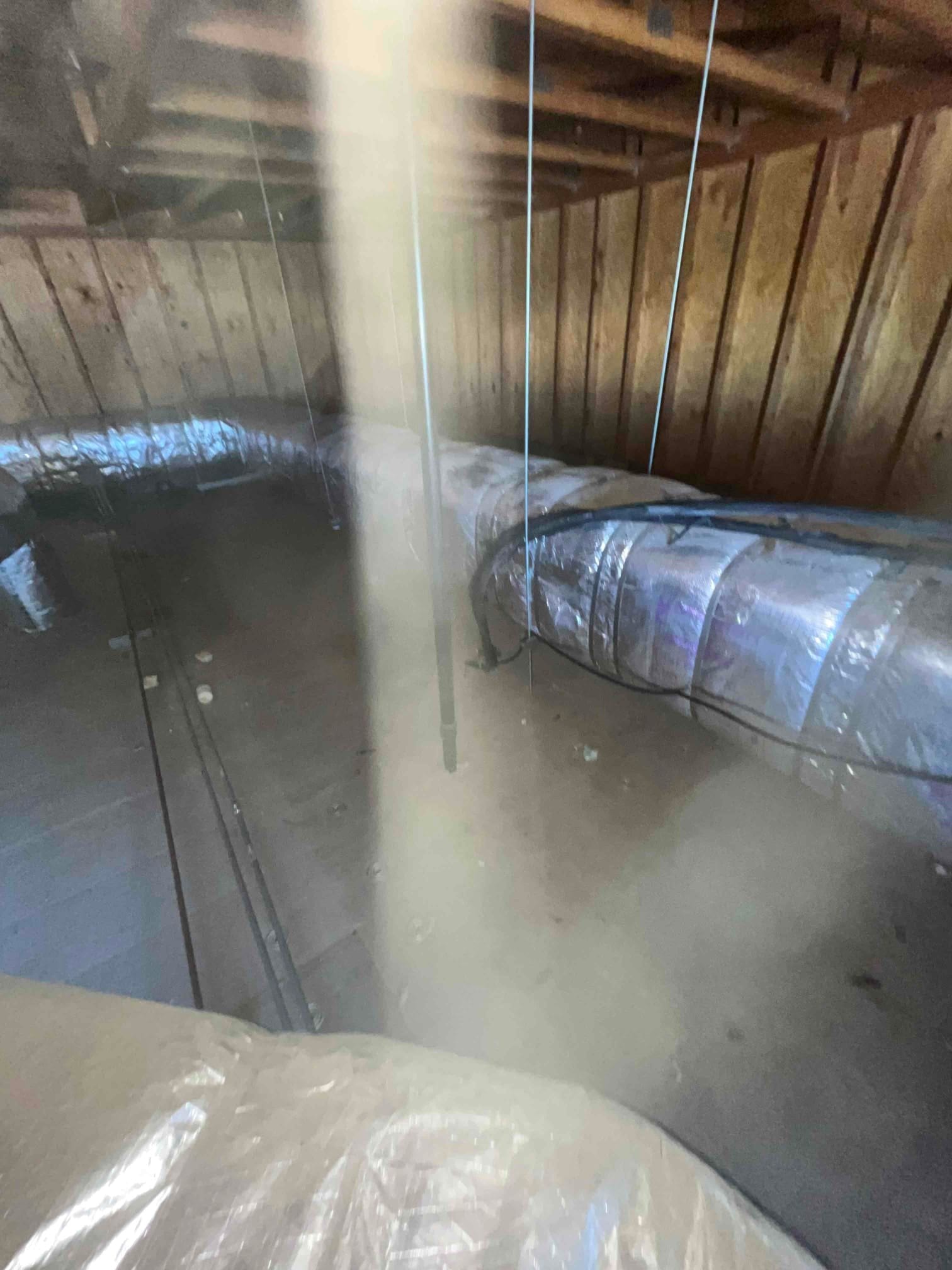 Insulated flexible ductwork routed through the attic, suspended from framing with hangers and supported for proper airflow.