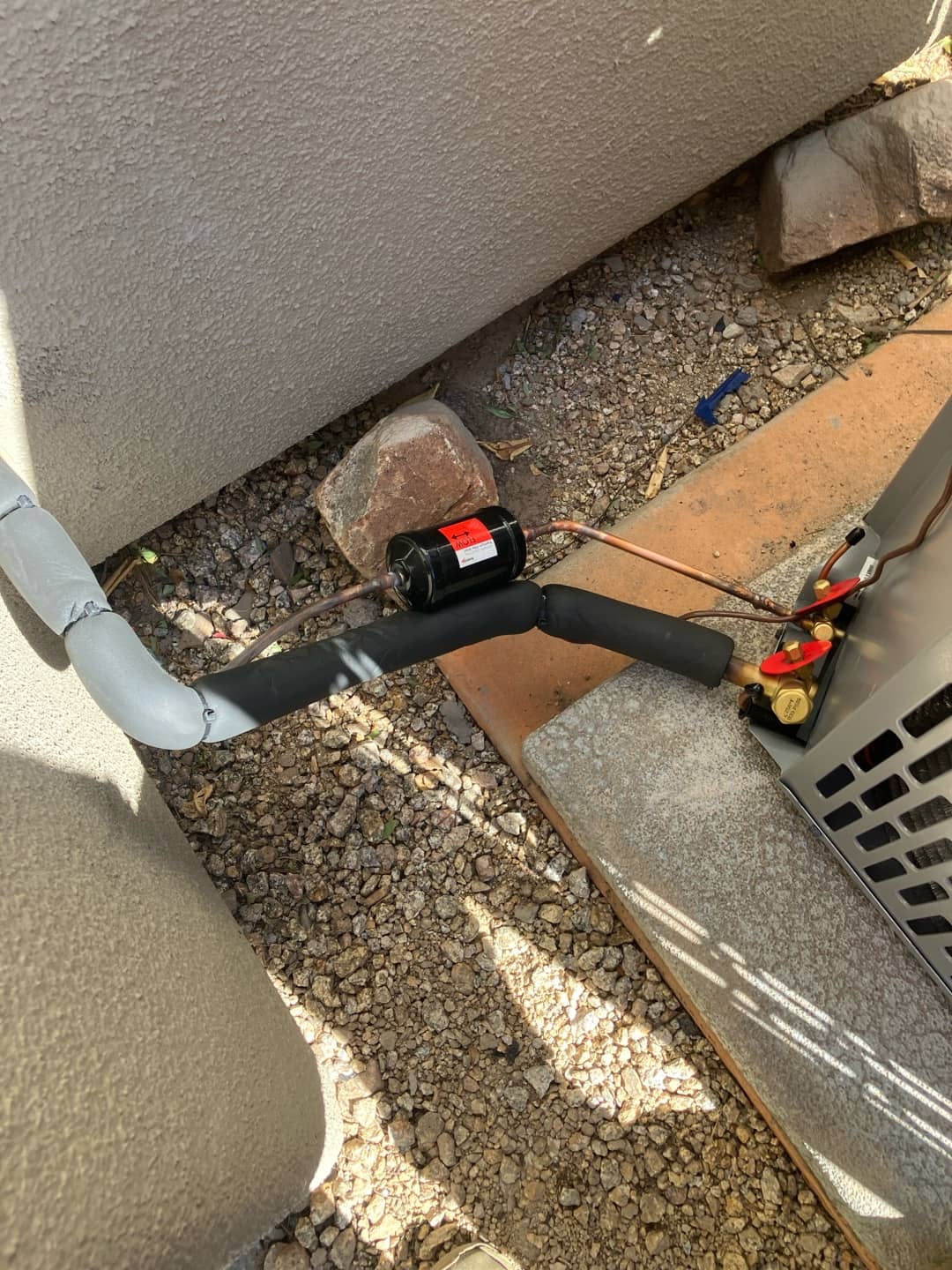 Insulated refrigerant line set with filter drier brazed in near the outdoor condenser on a new installation.