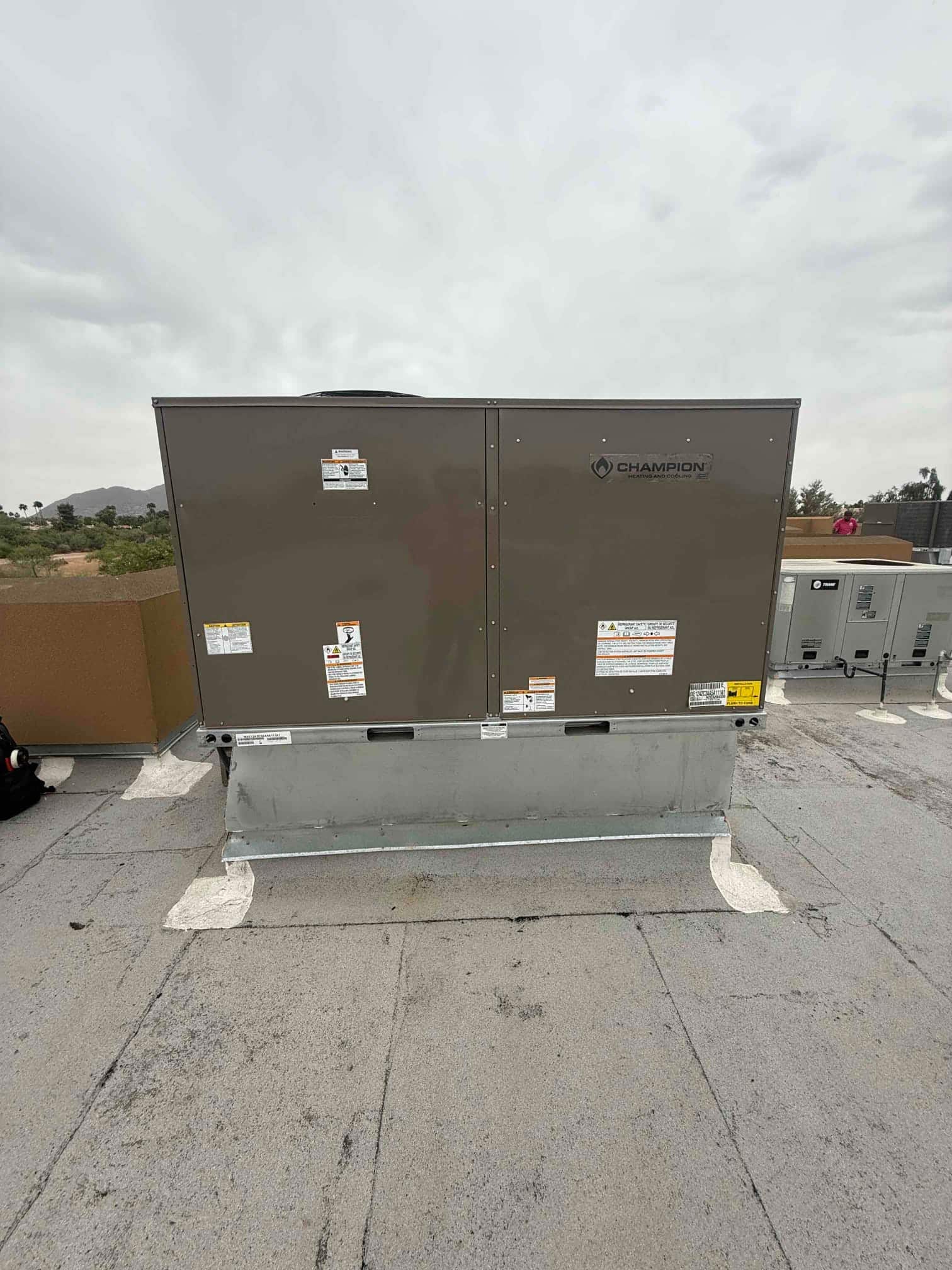 New rooftop package HVAC unit set on a curb with sealed flashing, photographed after installation on the roof.