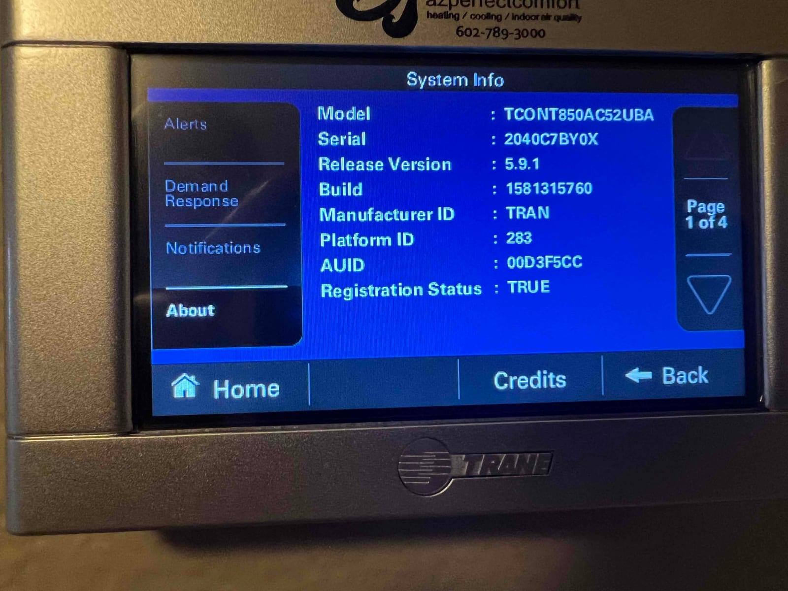 Thermostat system information screen displayed after installation, showing model, serial, software version, and registration status.