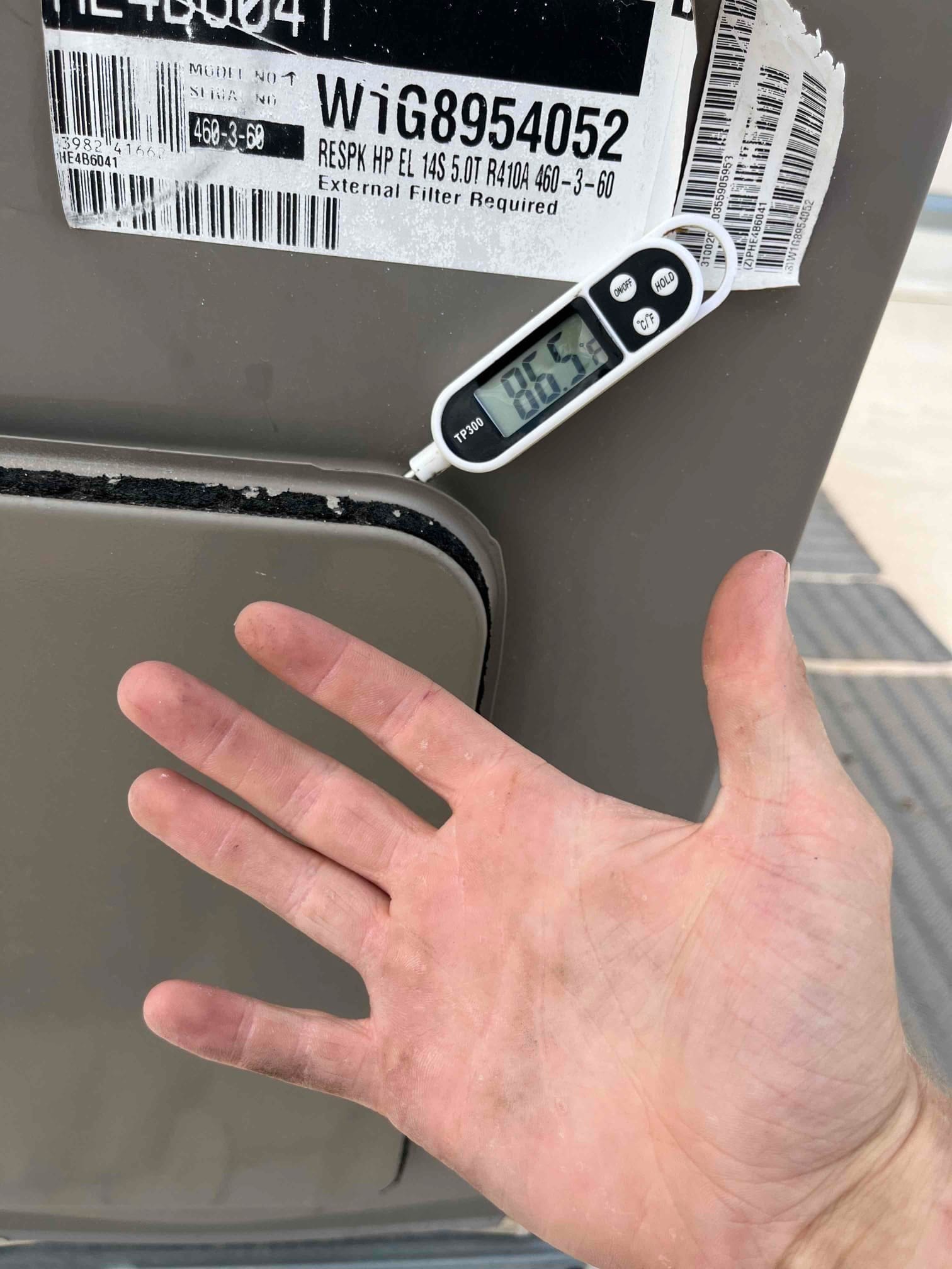 Digital thermometer shows 85.5 °F on the outdoor unit’s panel near the service compartment.