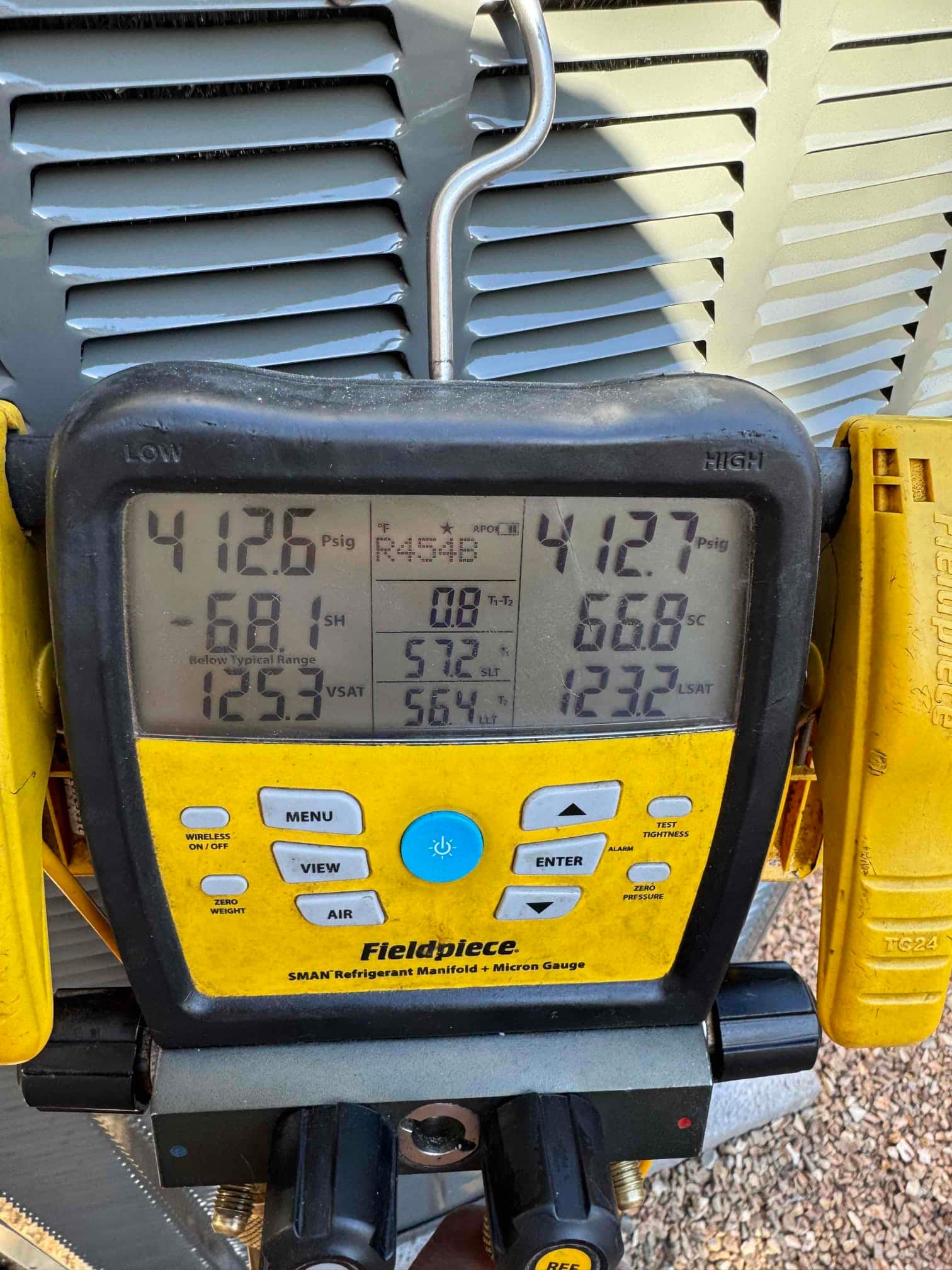 Digital manifold gauges show equal pressures around 413 PSI on both sides during a nitrogen pressure test of the new system.