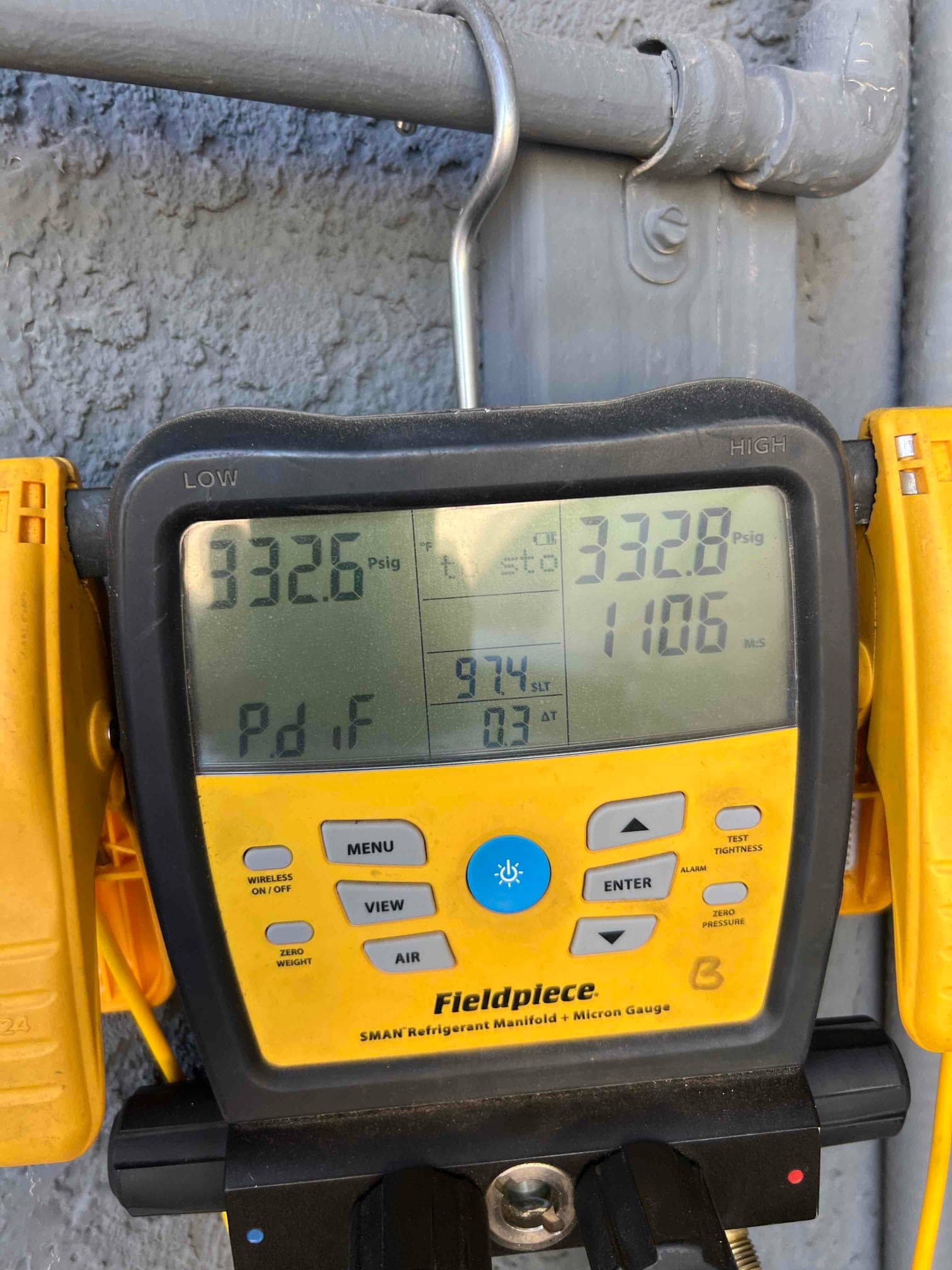 Digital manifold shows equalized pressures around 332–333 PSI on both sides during a nitrogen pressure test of the system.